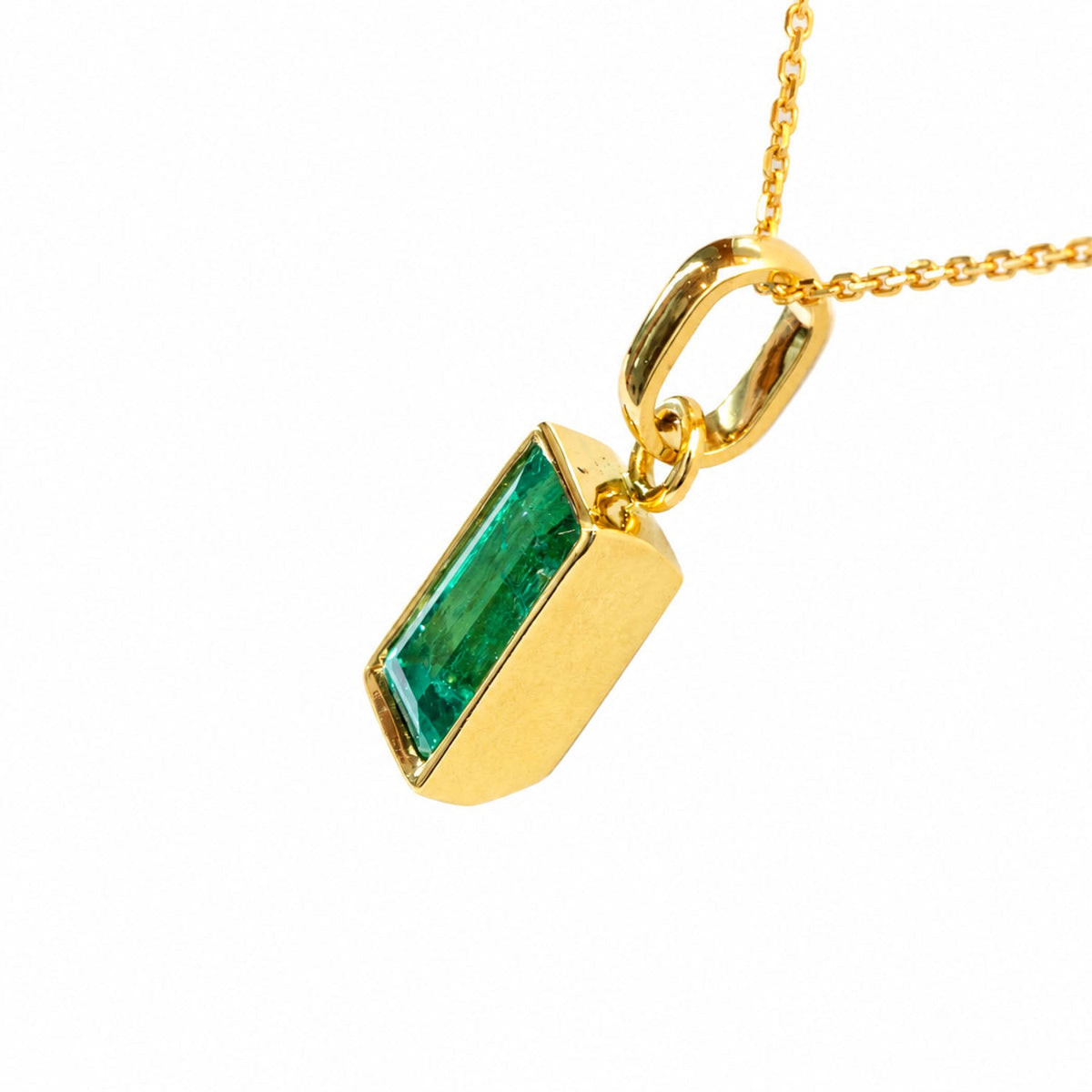 Colombian emerald pendant turned to show the bail and bezel depth