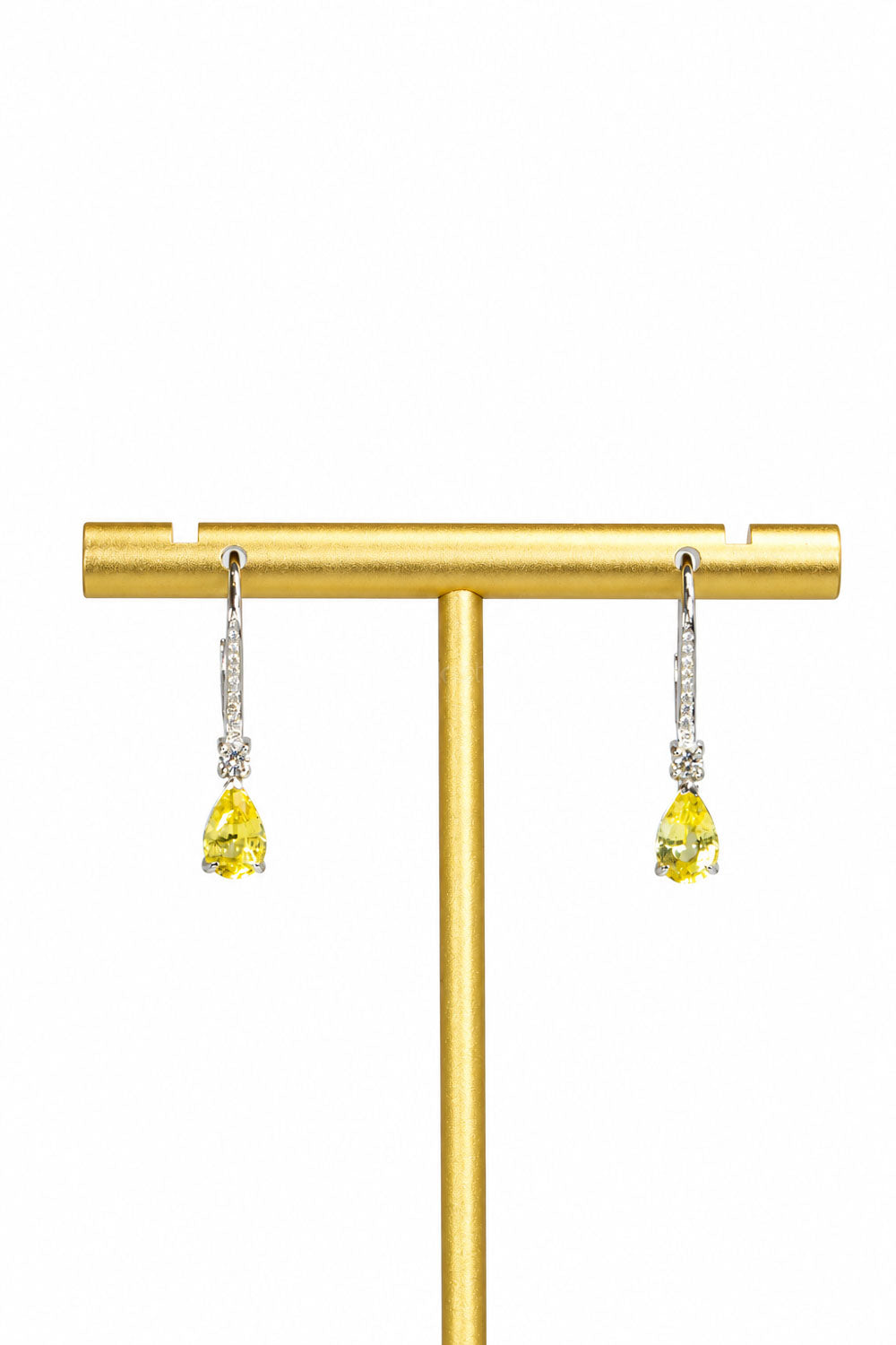 Pair of yellow sapphire and diamond drop earrings on a gold stand