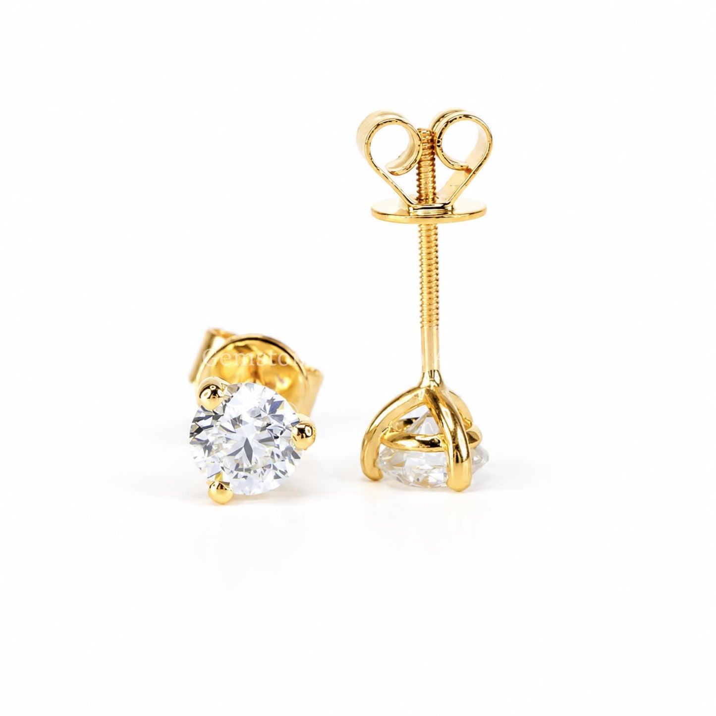 A pair of diamond stud earrings in yellow gold one showing the front and the other one showing the post and screw back closure.