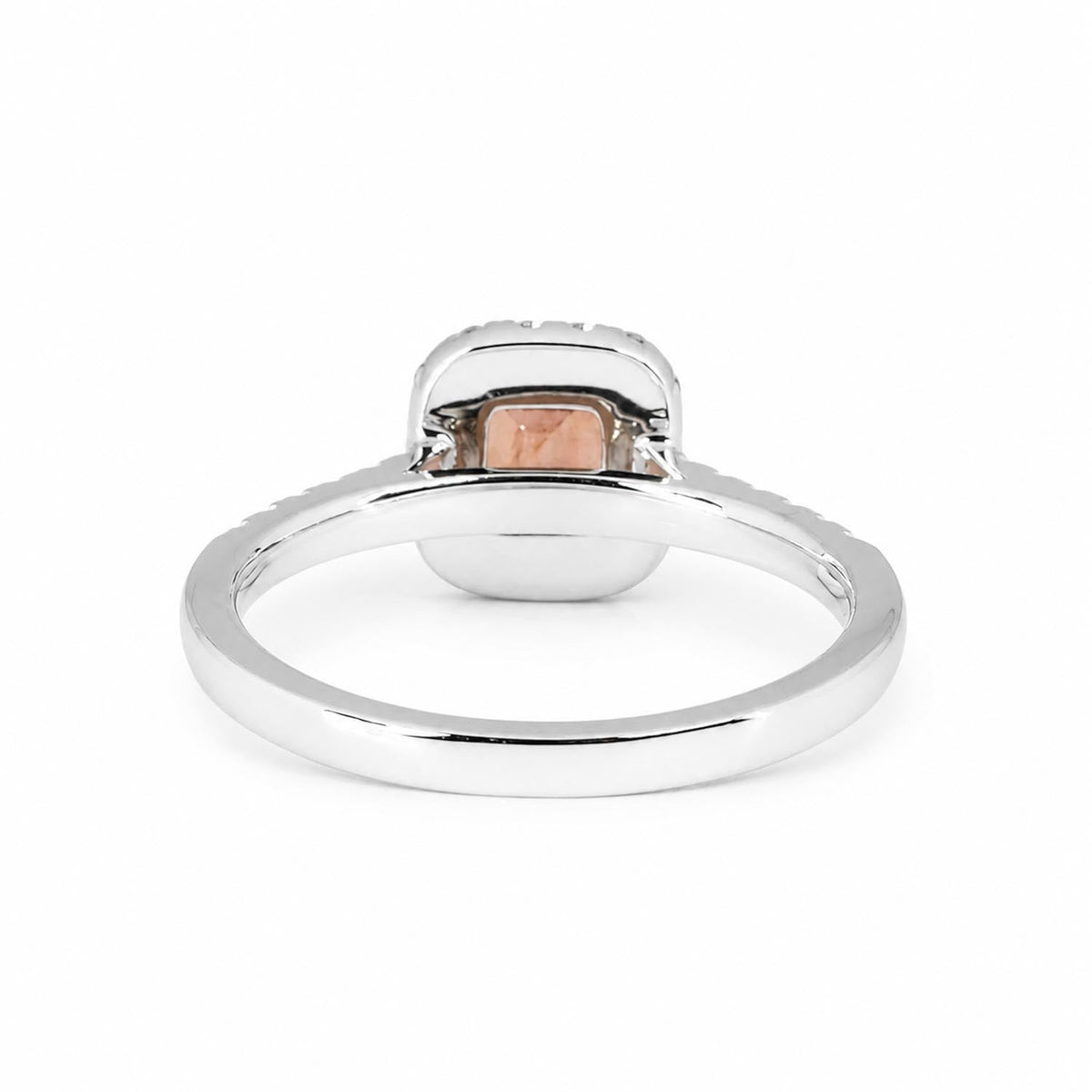 Side view of padparadscha sapphire halo ring in platinum