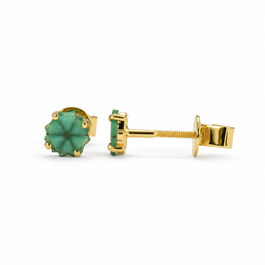 A pair of gold stud earrings with trapiche emeralds, shown on a clean white background. One earring is oriented to show the front of the Colombian emerald, while the other is turned sideways to display the gold post and butterfly back.