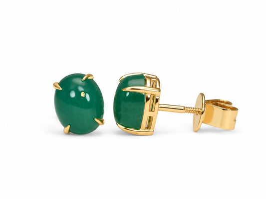 Emerald cabochon studs in 18K yellow gold shown at an angle