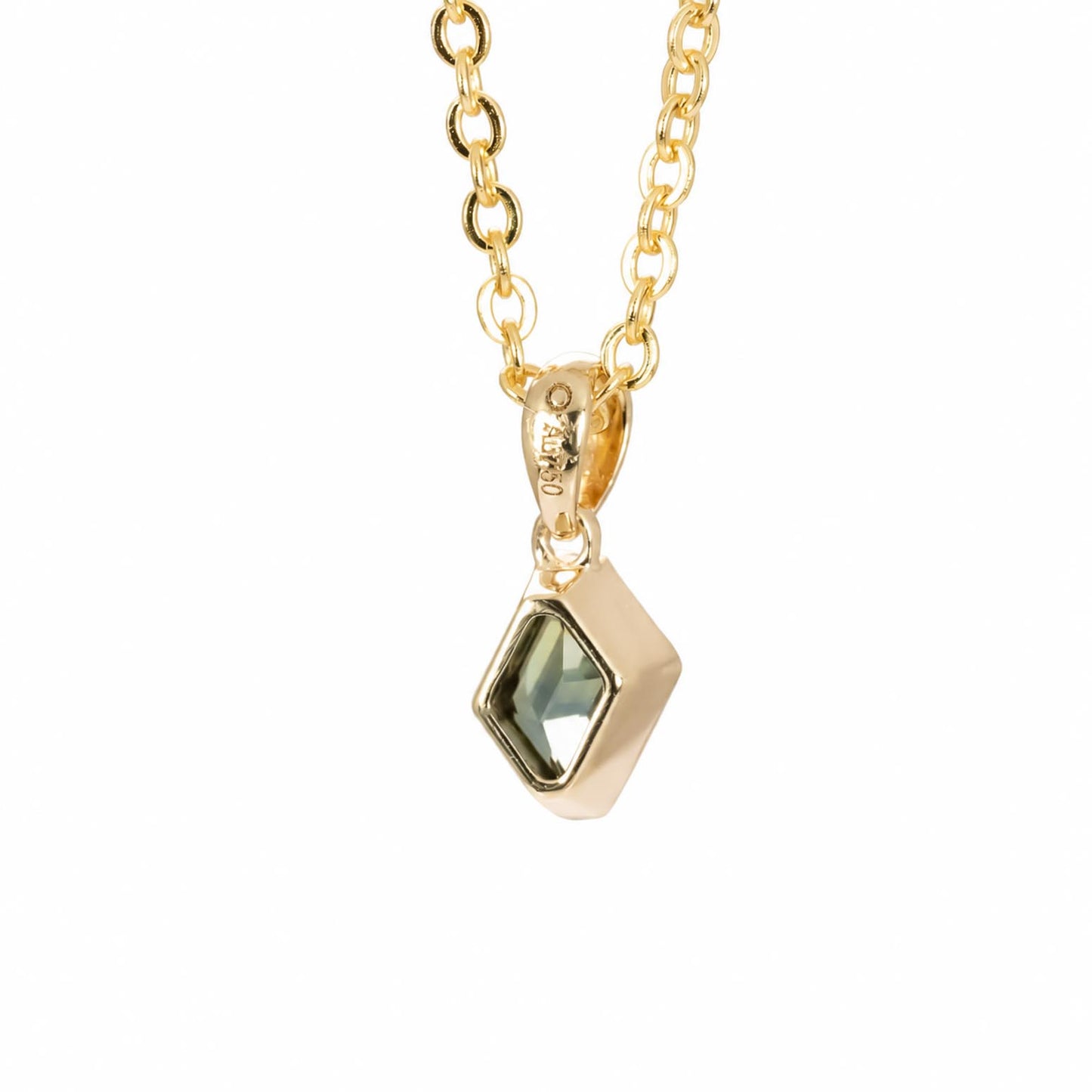 back view of a gold chain necklace with a geometric pendant featuring a teal green sapphire, shown against a plain white background.