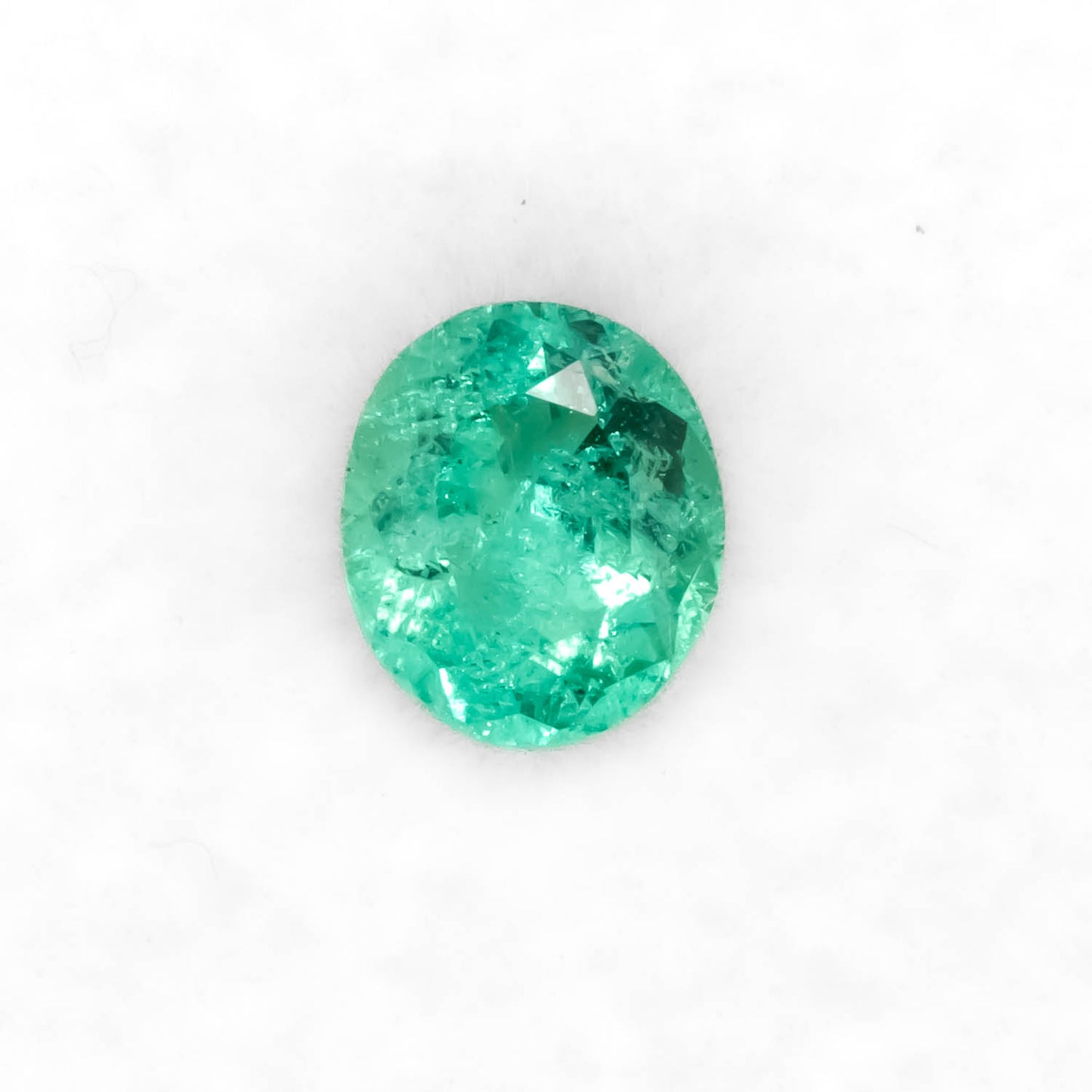 Front view of 0.79CT Natural Colombian Emerald – Round Cut Vivid Green Gemstone in white background.
