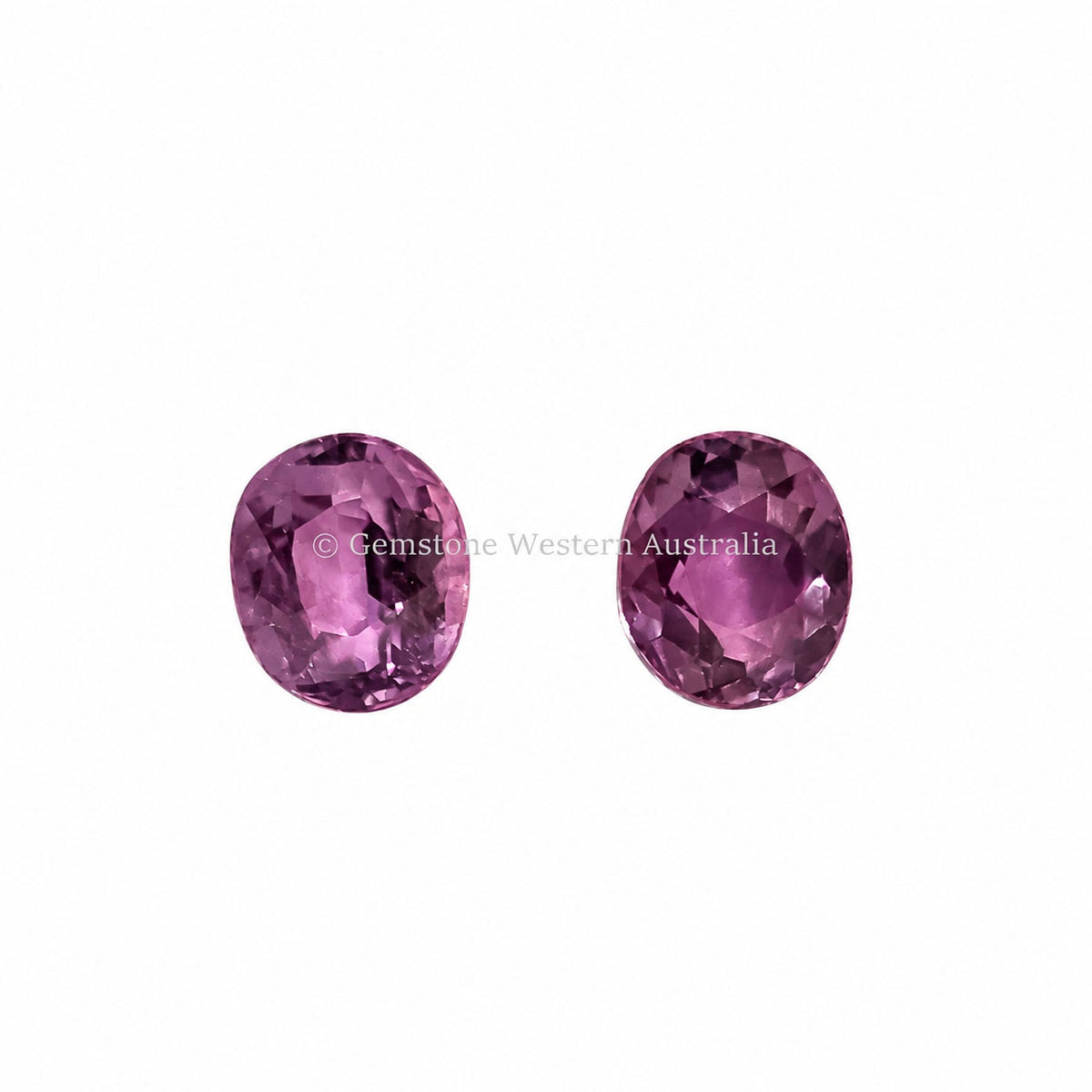 1.02 ct alexandrite pair under warm light showing their colour change