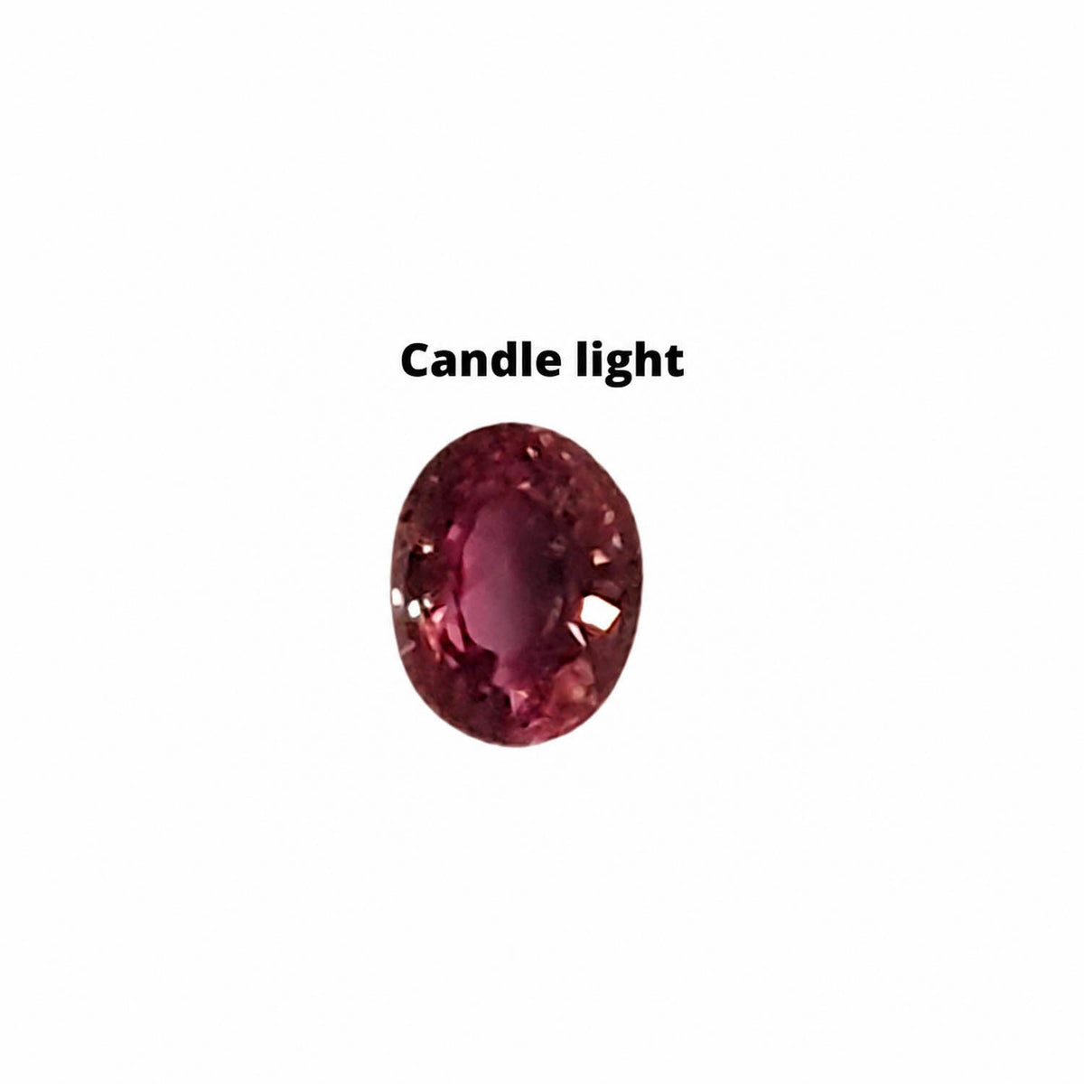 0.57 ct alexandrite under warm light showing its colour change