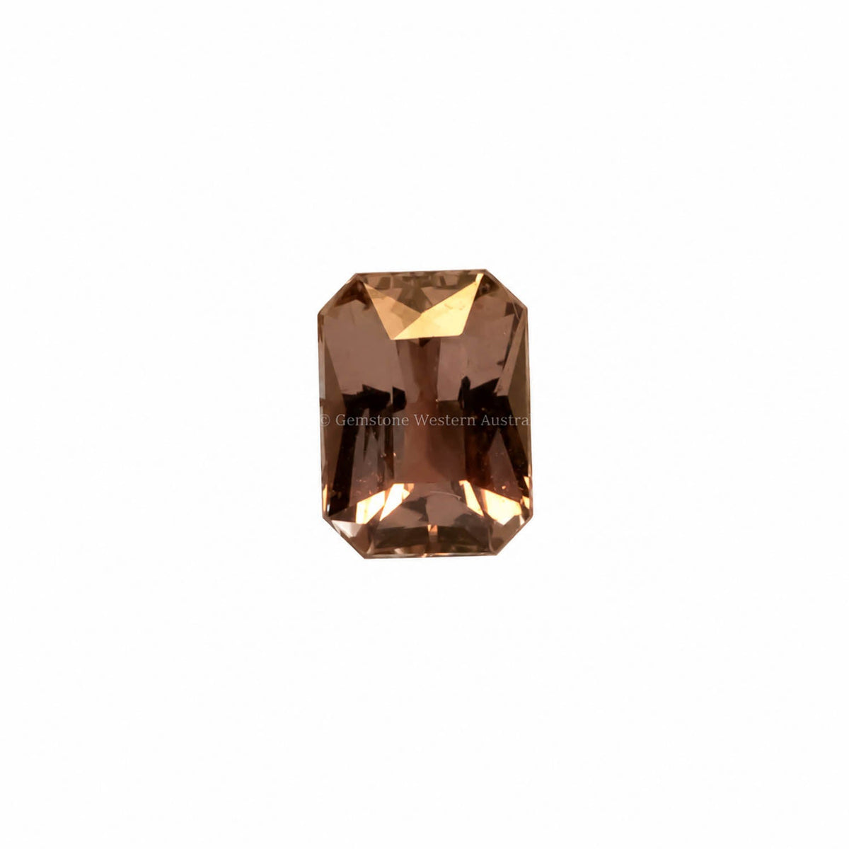 2.07 ct unheated brown pink sapphire shown under warm light