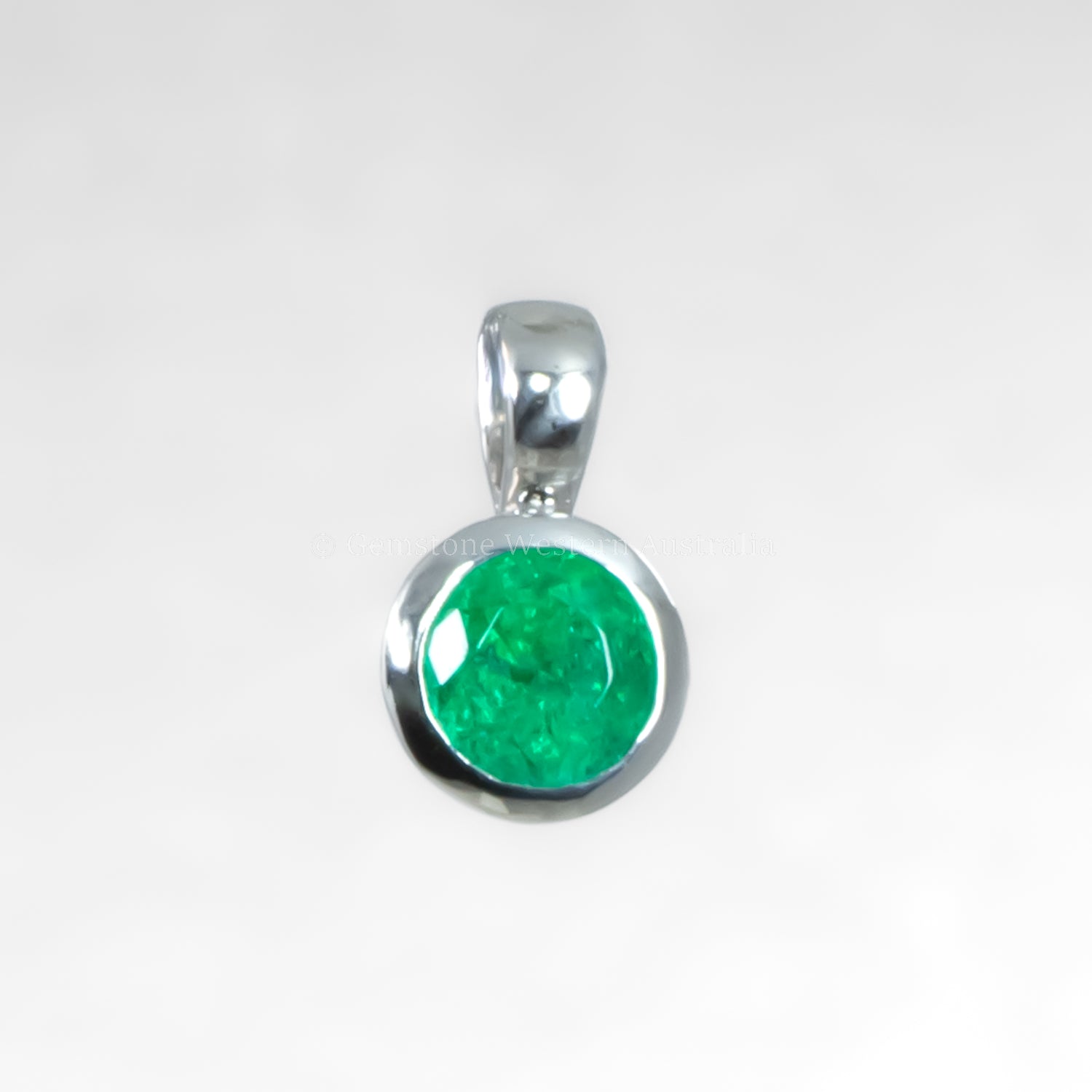 platinum pendant with a green stone on a white background