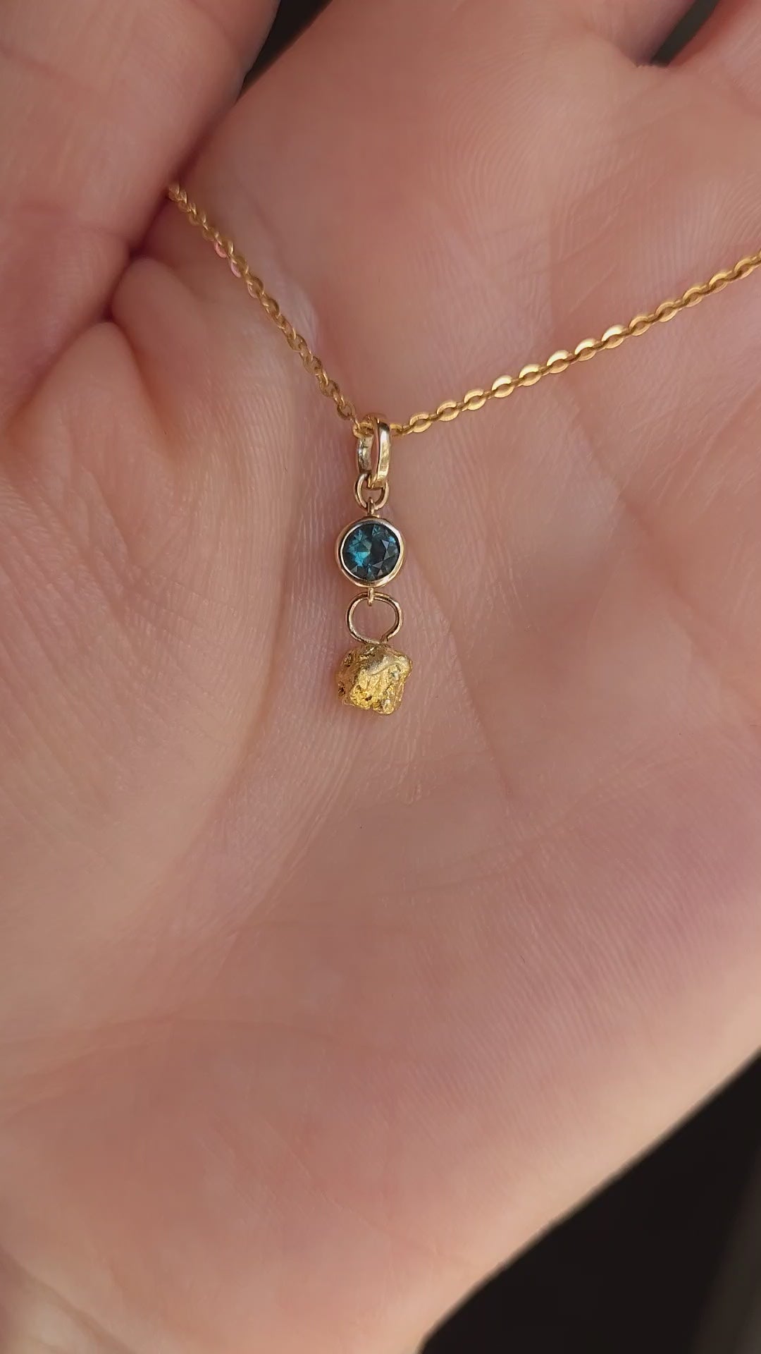video on hand of sapphire and gold nugget pendant