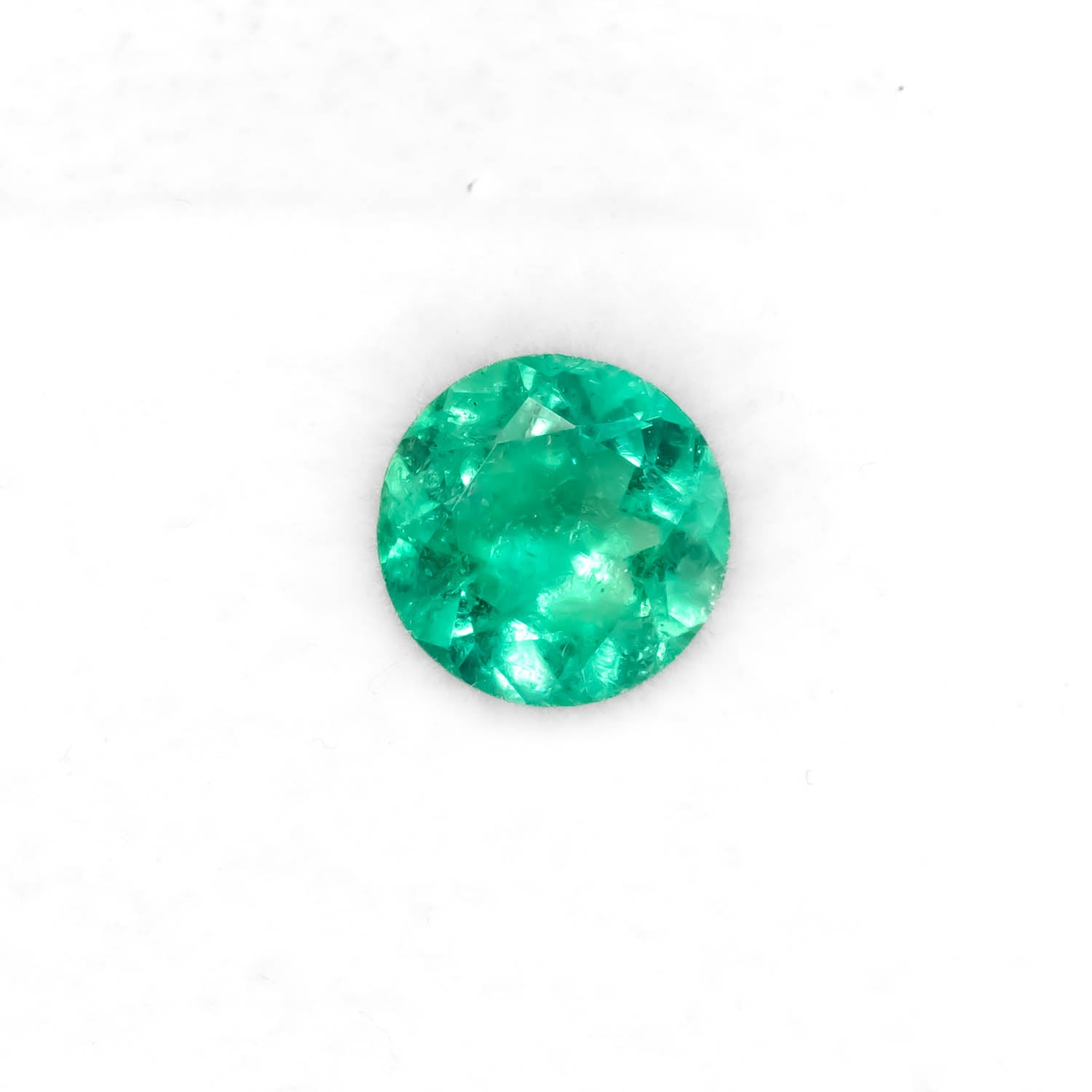 Front view of 1.51CT Natural Colombian Emerald – Round Cut Vivid Green Gemstone in white background.