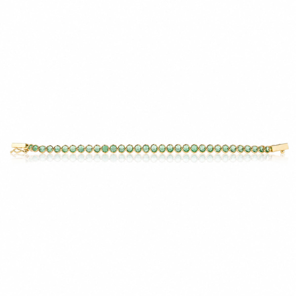 Back view of a delicate gold tennis bracelet with small round Colombian emeralds, displayed horizontally on a clean white background.