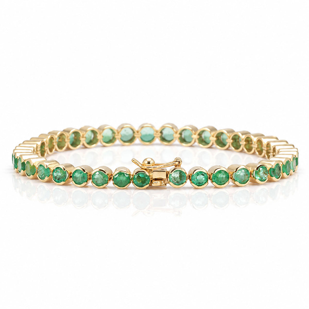 A yellow gold tennis bracelet featuring round Colombian emeralds and showing a box clasp with safety latch