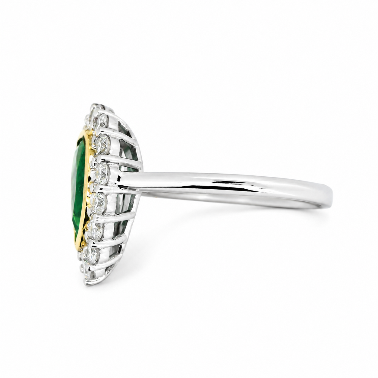 A white and yellow gold ring featuring a Colombian emerald pear-cut center stone surrounded by diamonds in a scalloped setting, shown on a plain white background.