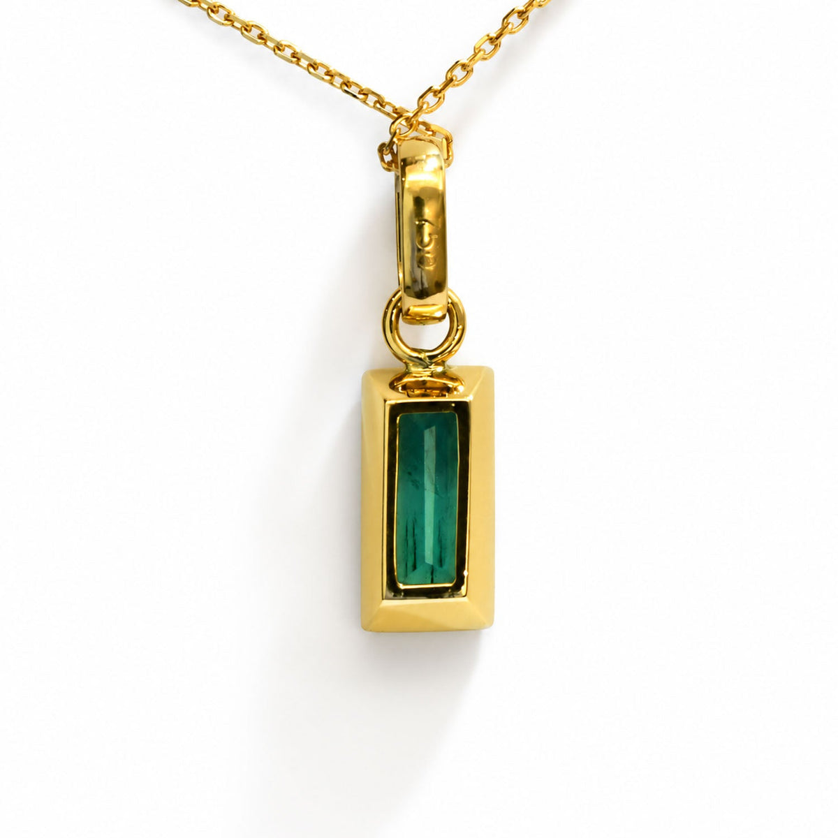 Emerald-cut Colombian emerald in an 18K gold bezel, front view
