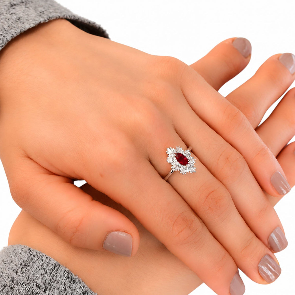 Art Deco ruby and diamond halo ring worn on the hand