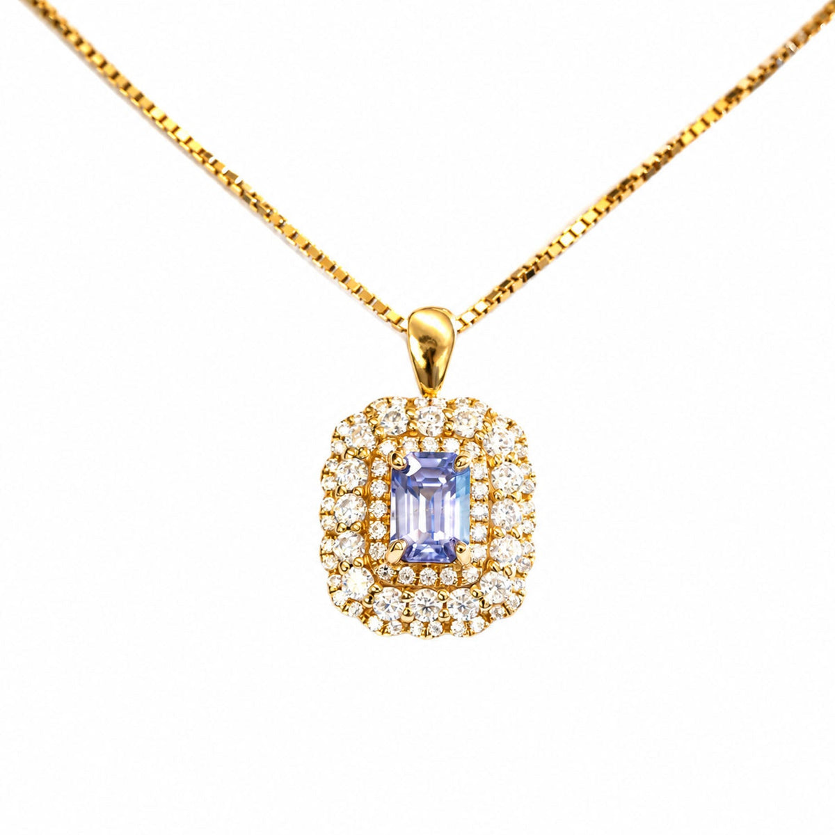 The same Ceylon sapphire piece worn as a pendant on a gold chain