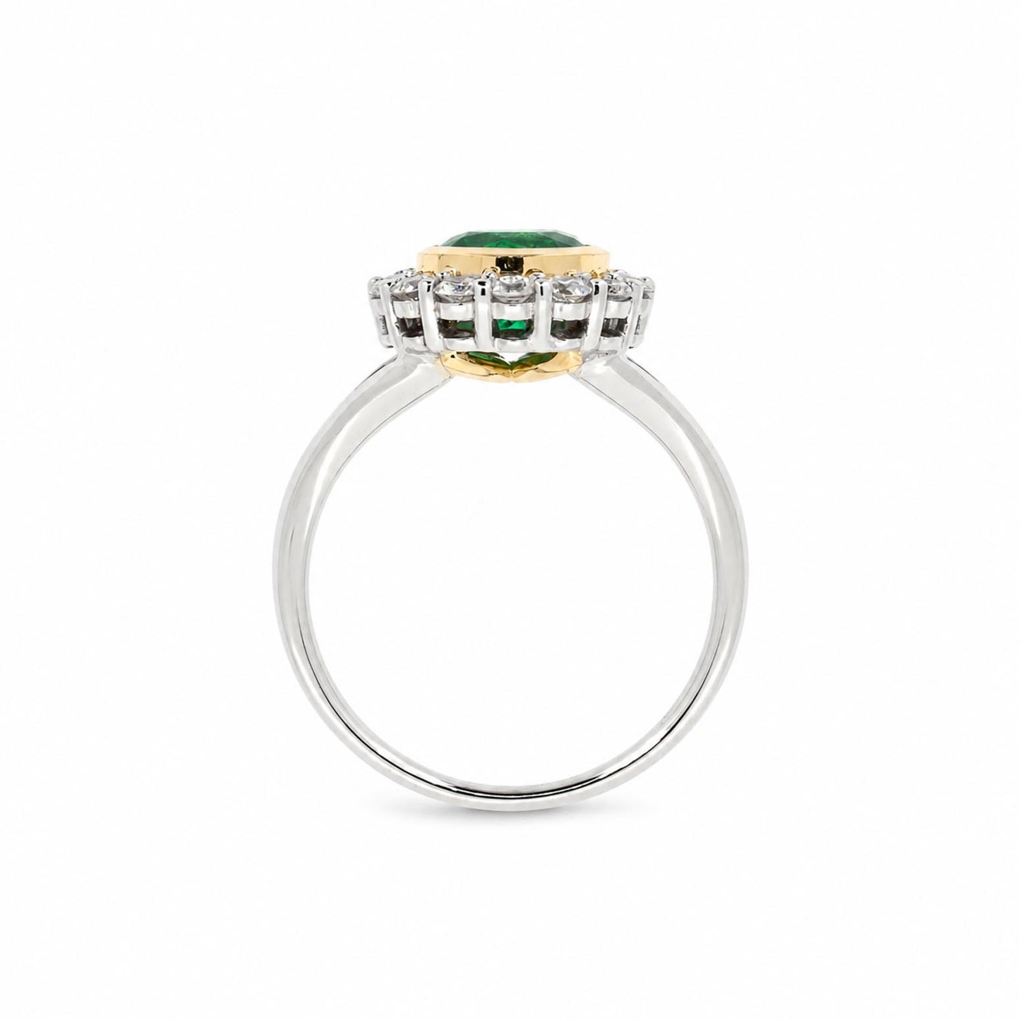 A yellow gold and white gold ring featuring a central Colombian emerald surrounded by diamonds set on a polished white gold band.