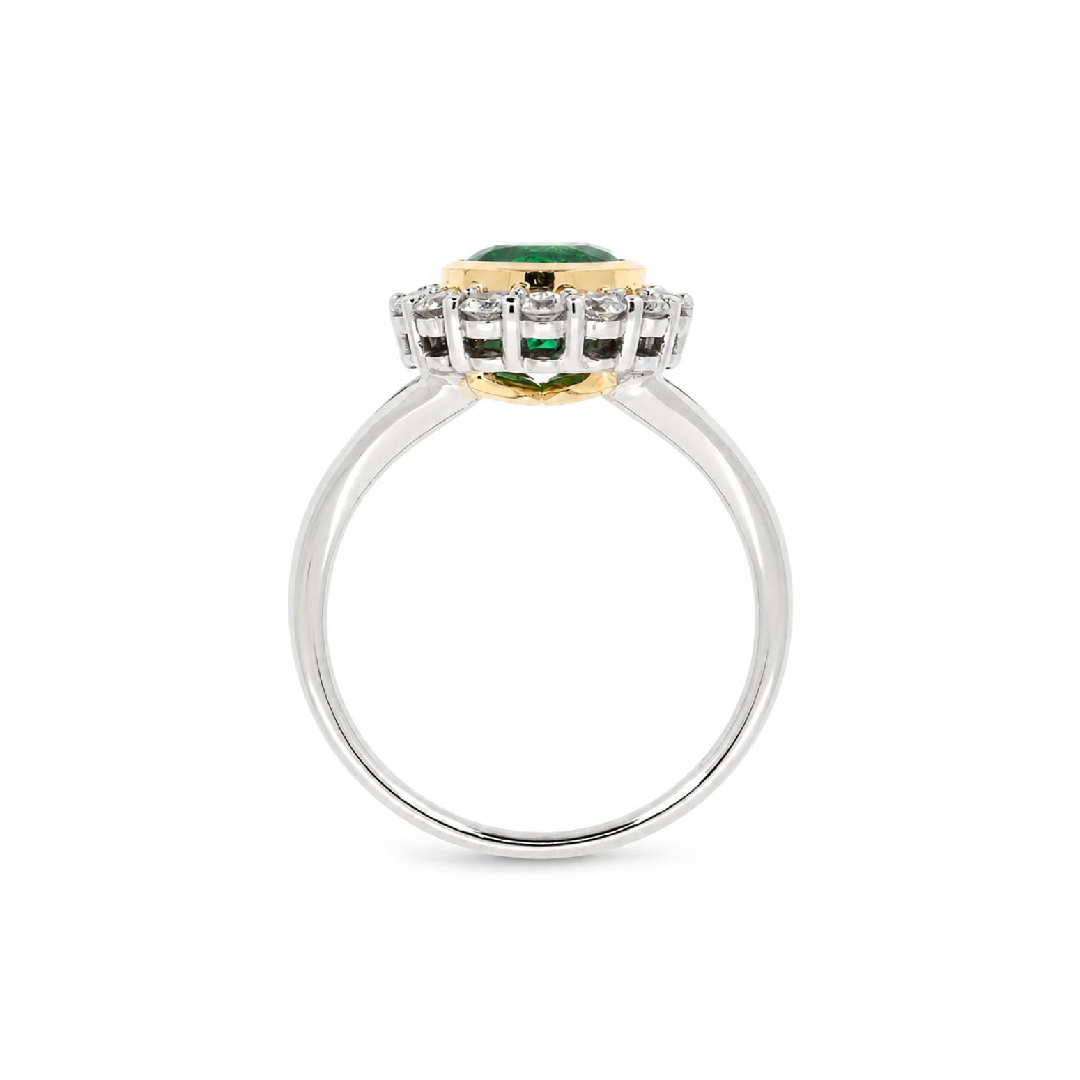 A yellow gold and white gold ring featuring a central Colombian emerald surrounded by diamonds set on a polished white gold band.