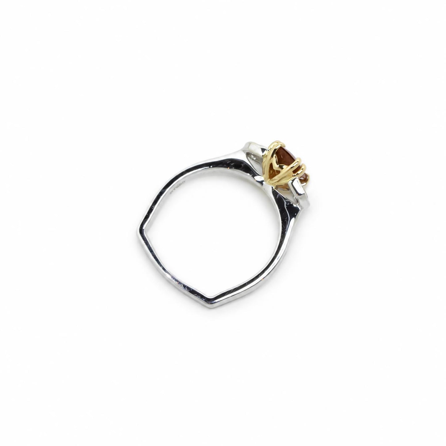 A two-tone ring featuring a polished platinum band and a 18K yellow gold setting holding a padparadscha sapphire gemstone, shown on a plain white background.