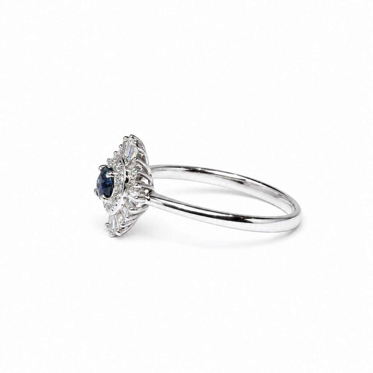 Side profile of the teal sapphire ring showing its raised halo