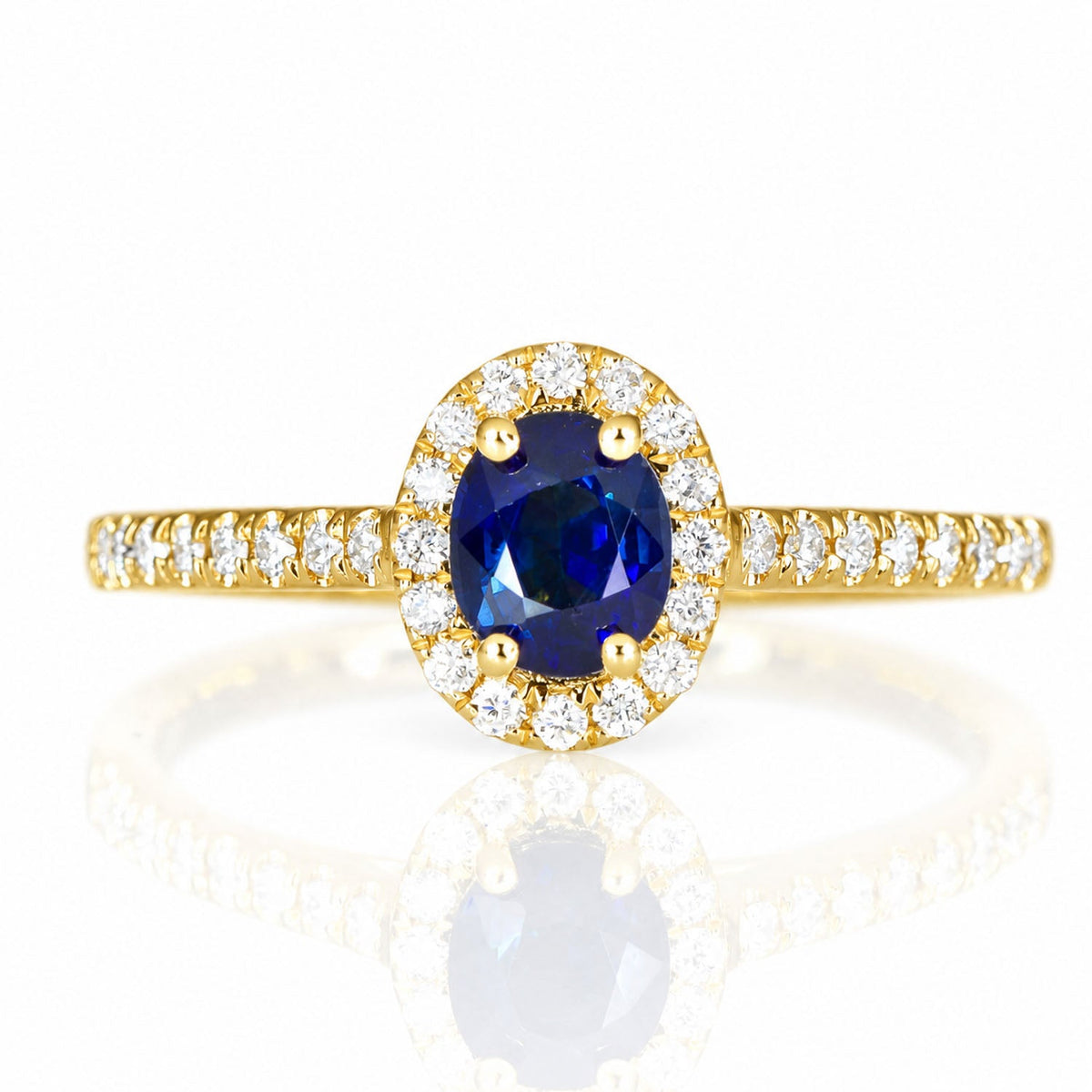 Unheated blue sapphire and diamond halo ring in 18K yellow gold