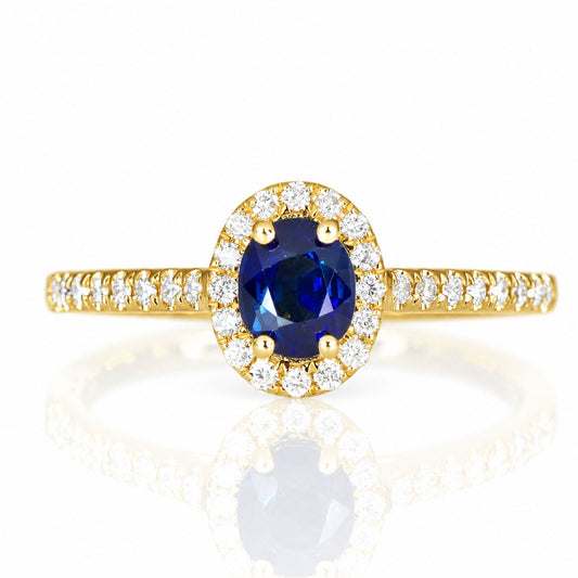 Unheated blue sapphire and diamond halo ring in 18K yellow gold