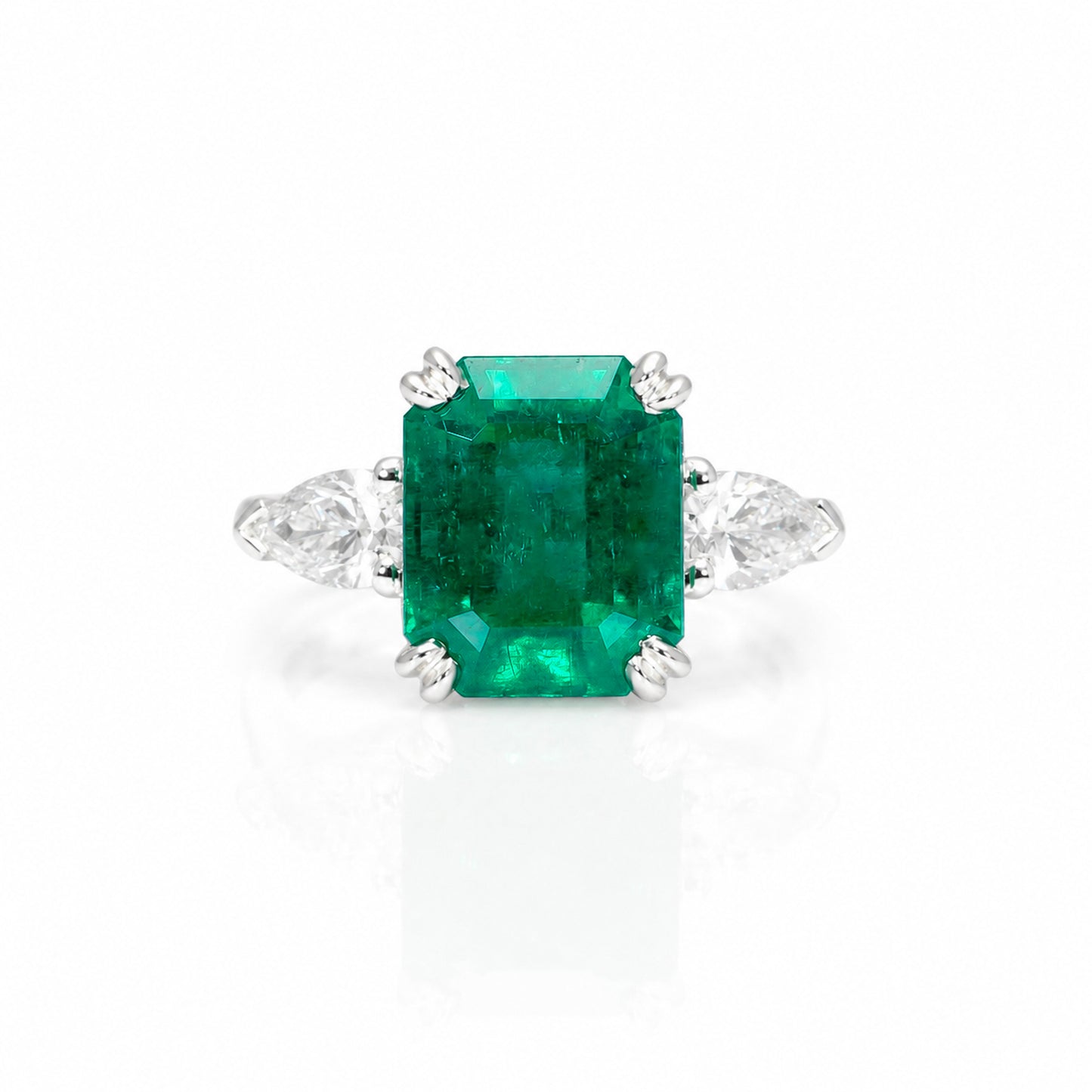 front view of a 6.46 Carats Colombian Emerald and Diamond Statement Ring with GIA Certified diamonds in a white background
