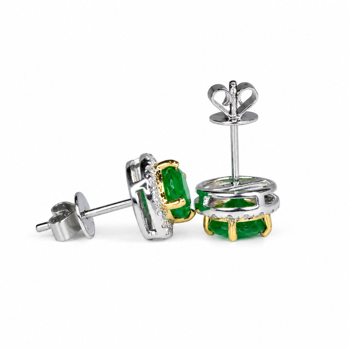 Colombian emerald halo studs shown from the side with their butterfly backs
