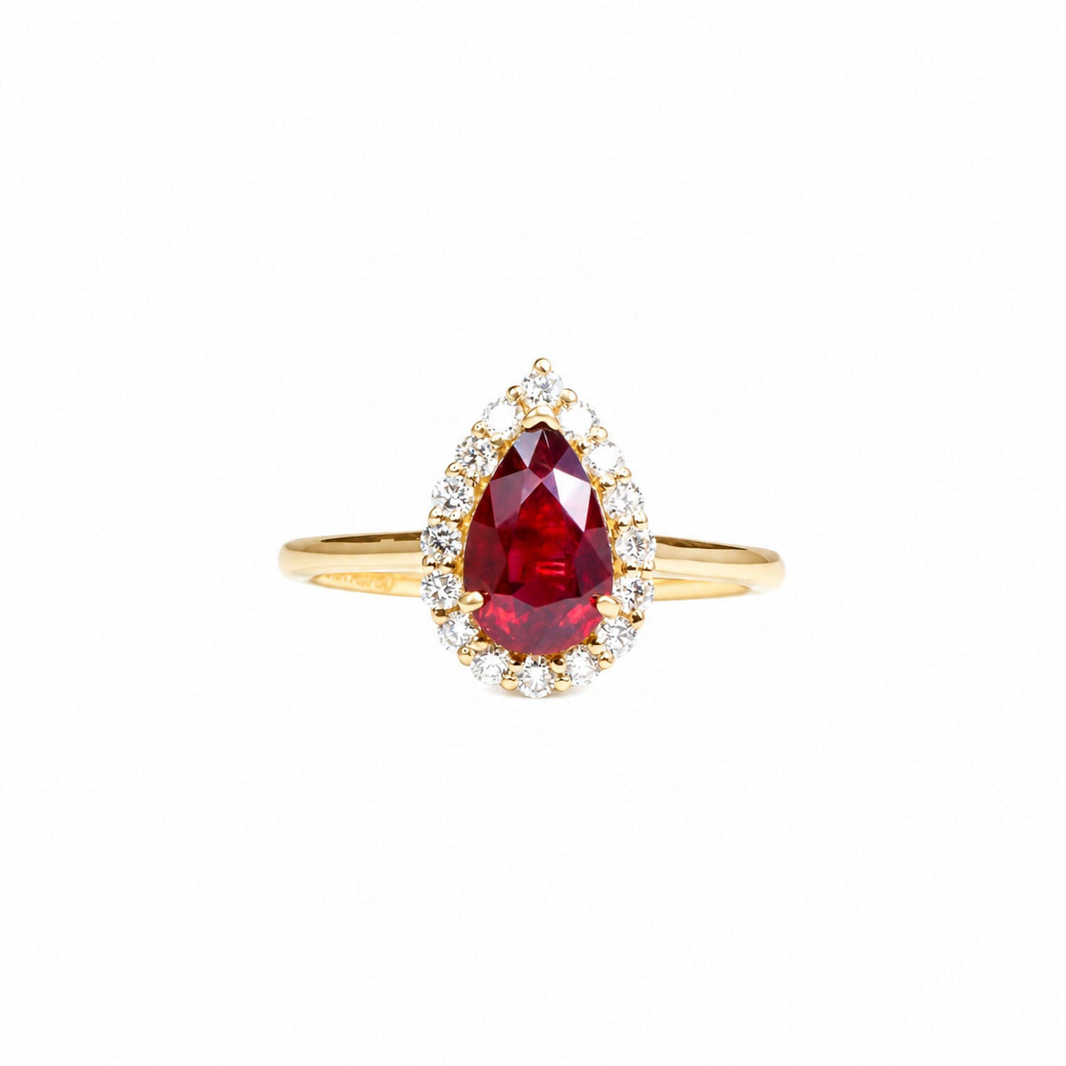 1.61 ct unheated pear-cut ruby with a diamond halo in yellow gold