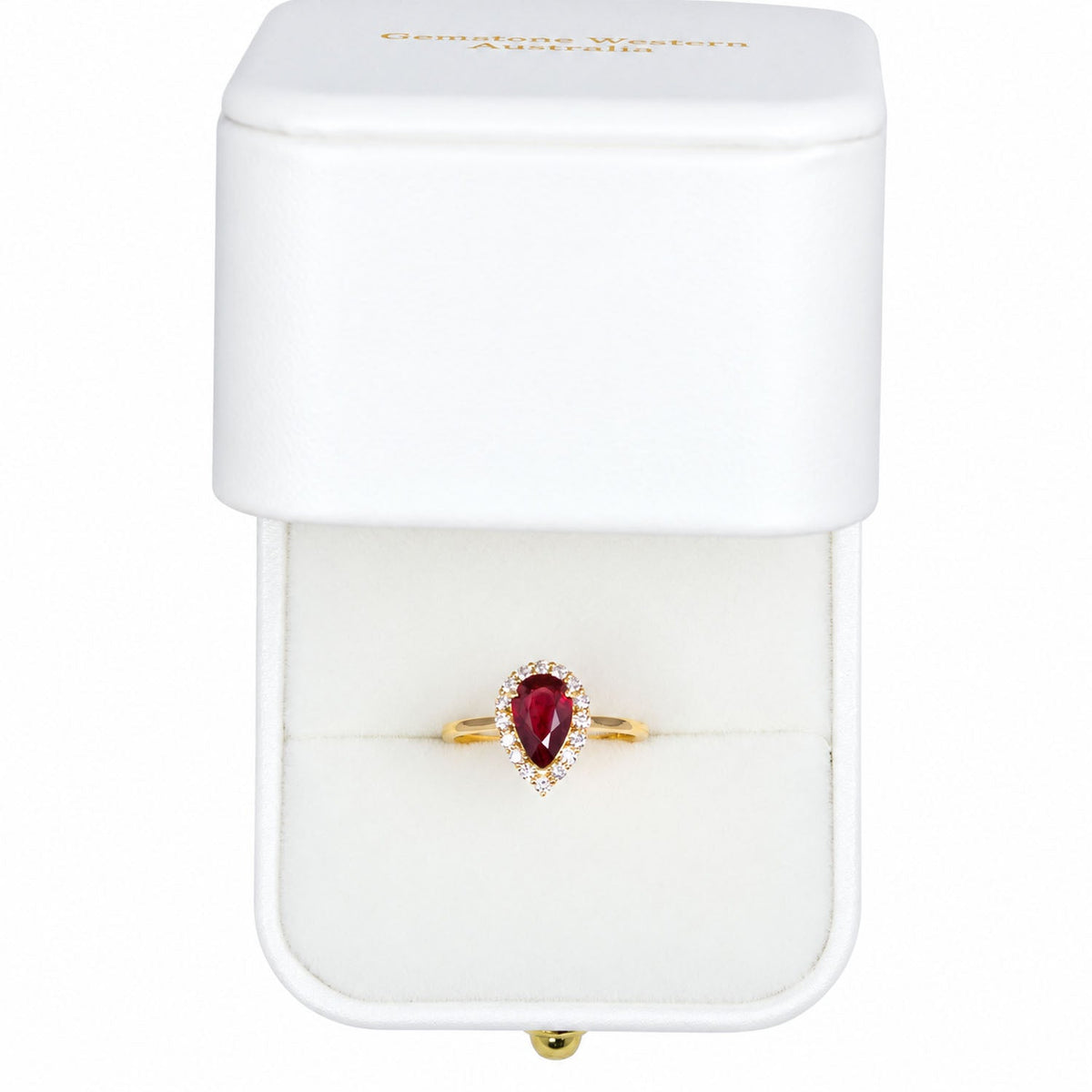 Pear ruby halo ring presented in its Gems and Gold box