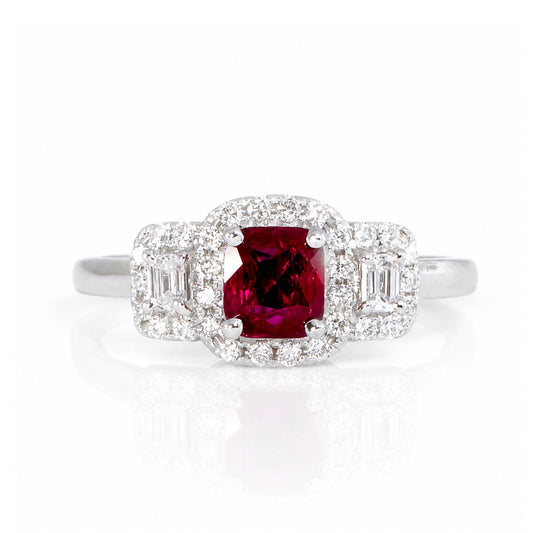 A three-stone ruby and diamonds ring surrounded by a halo of diamonds in a 18K white gold setting on a white reflective background