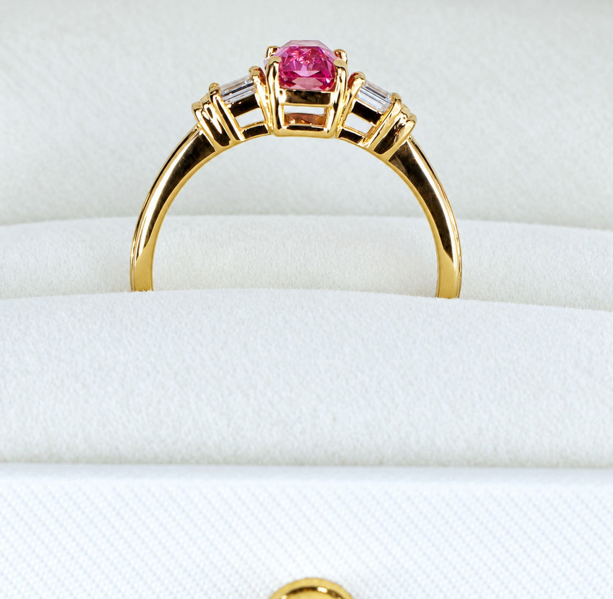 Close view of the padparadscha ring standing in its box