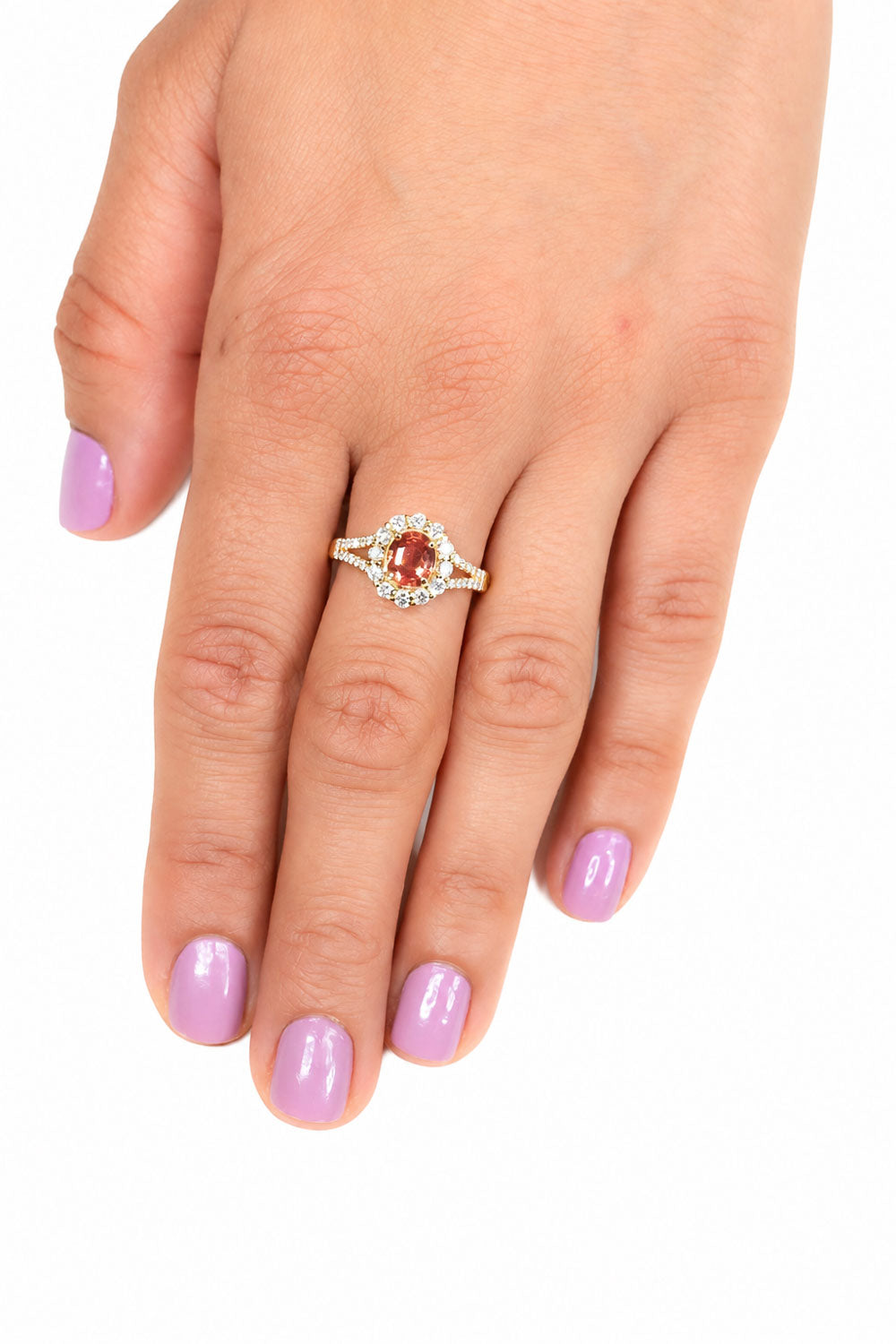 Padparadscha sapphire halo ring worn, hand resting