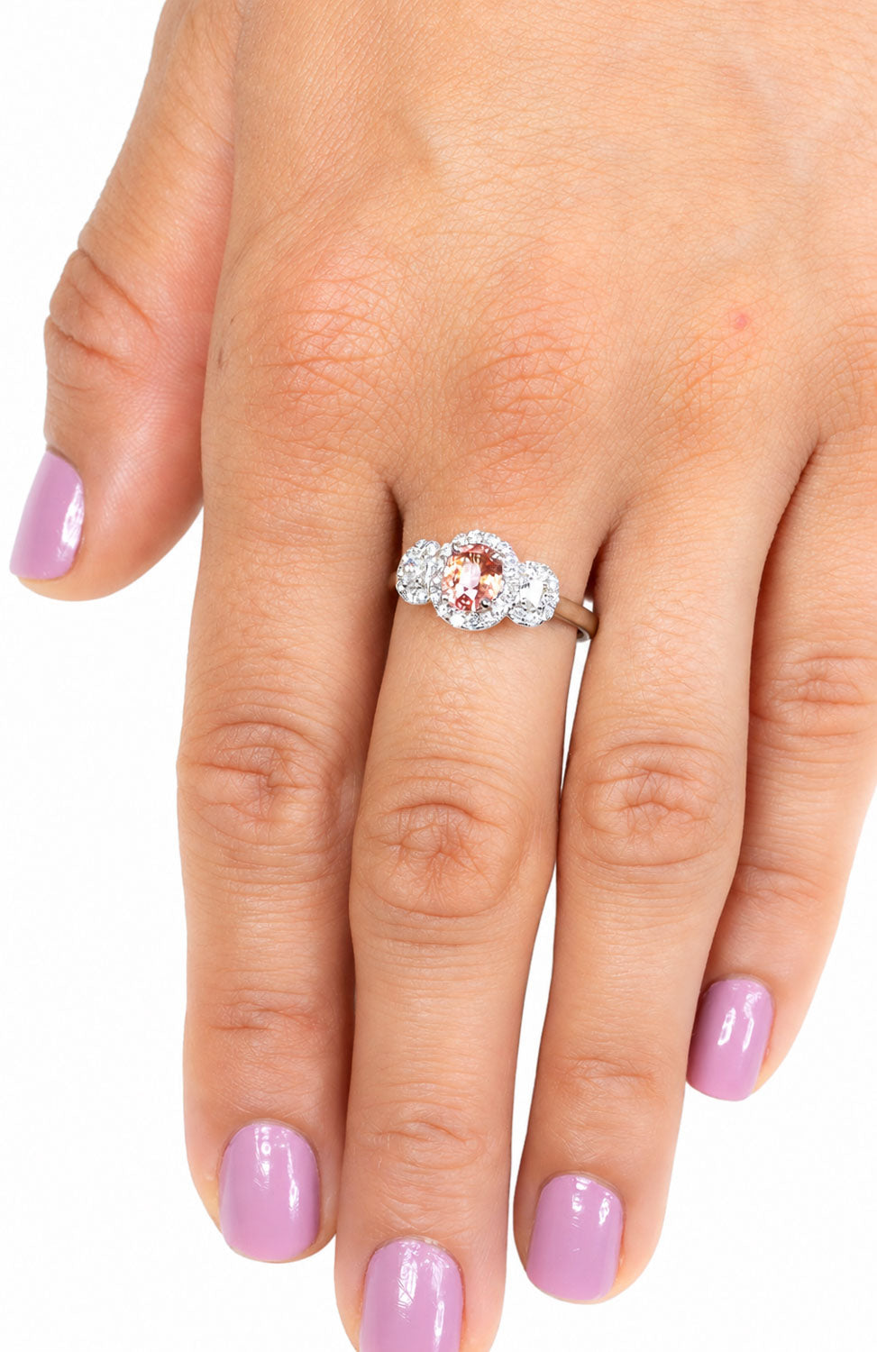 Padparadscha three stone ring worn on the hand