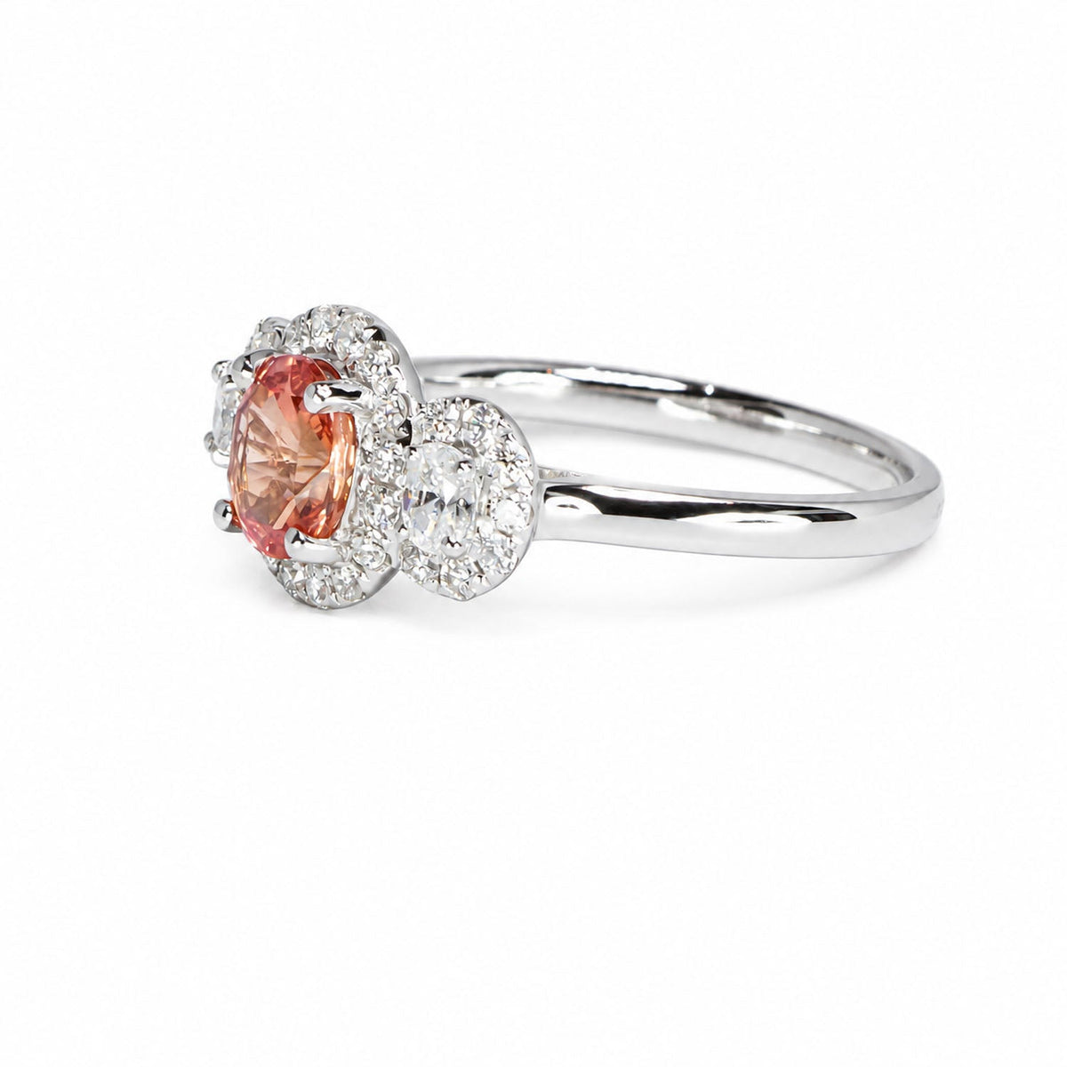 Side profile of the padparadscha three stone halo ring