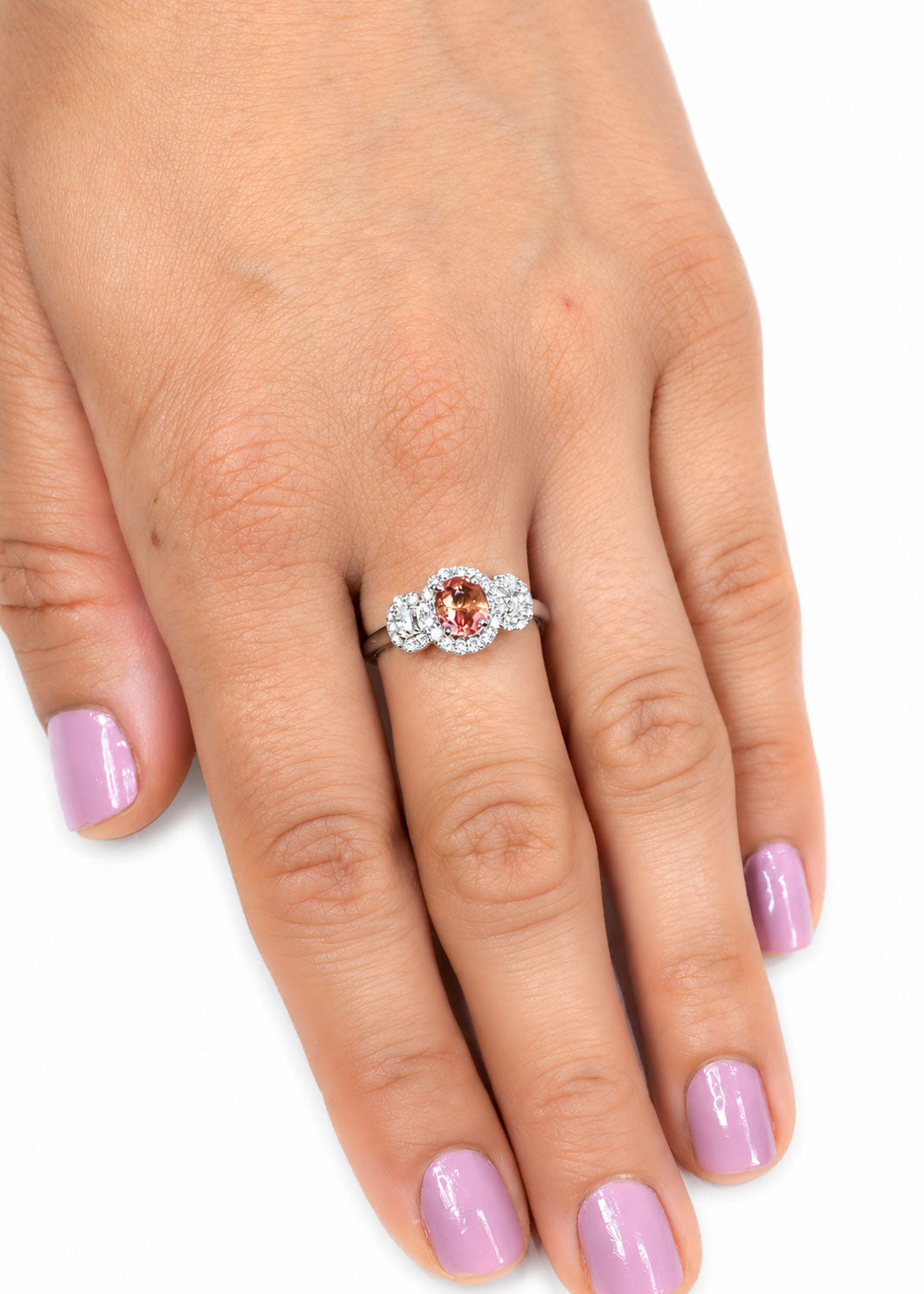 Padparadscha three stone ring worn, hand resting
