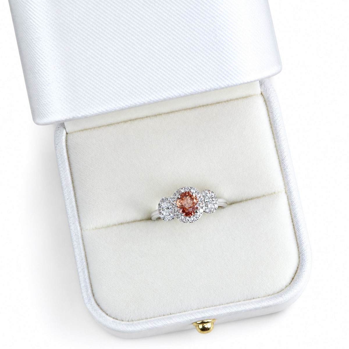 Close view of the padparadscha ring standing in its box