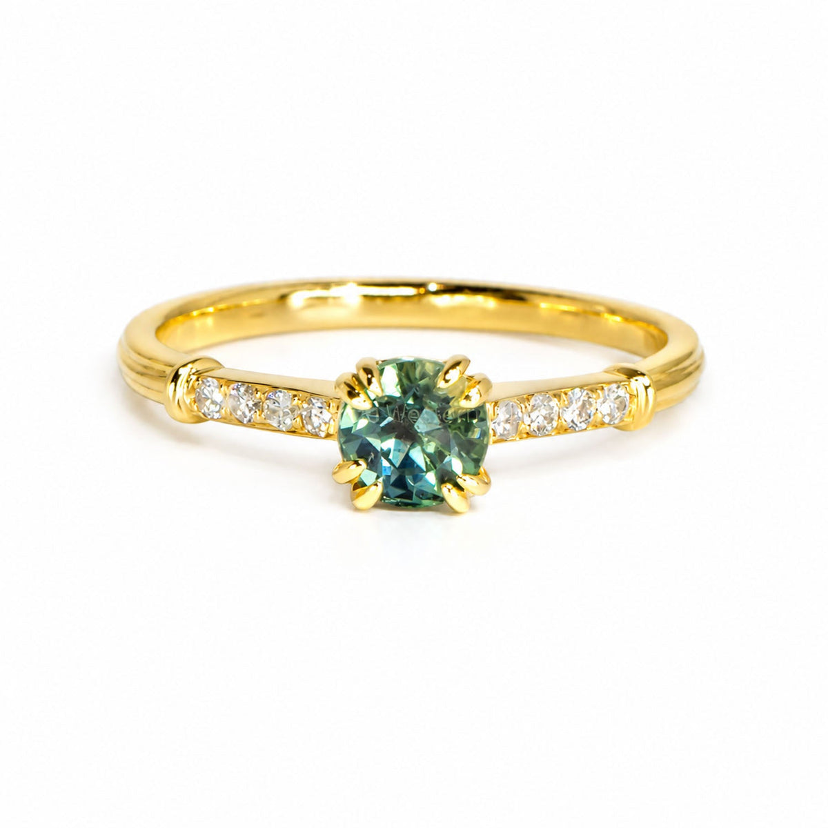 Unheated teal sapphire ring with diamond-set shoulders in 18K yellow gold