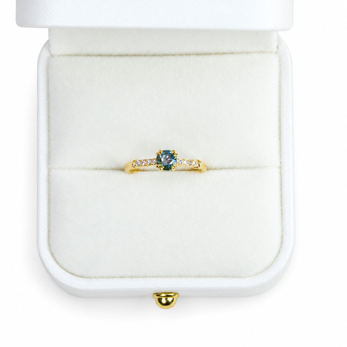 Teal sapphire ring presented in its white gift box