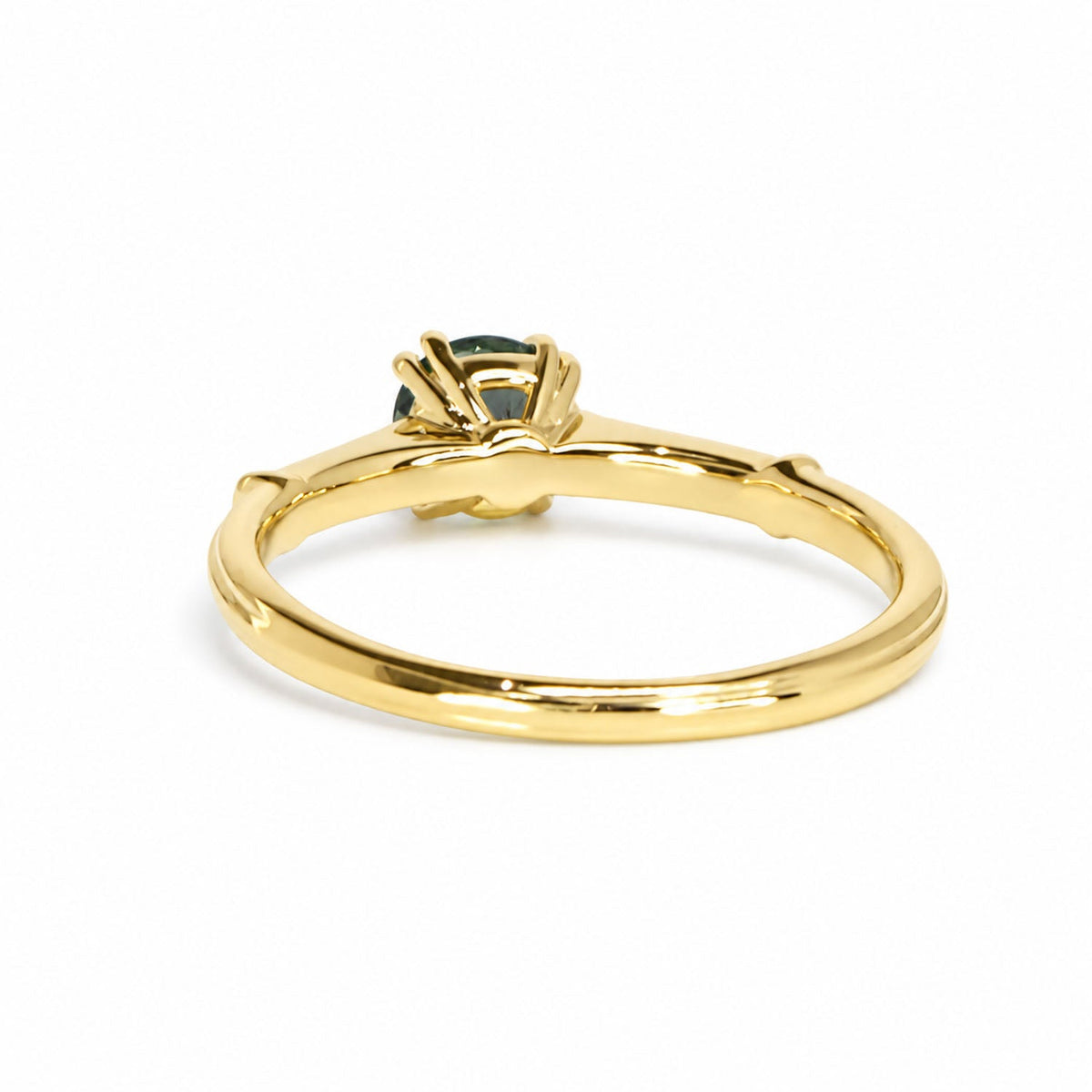 Back of the teal sapphire ring showing the open gold gallery
