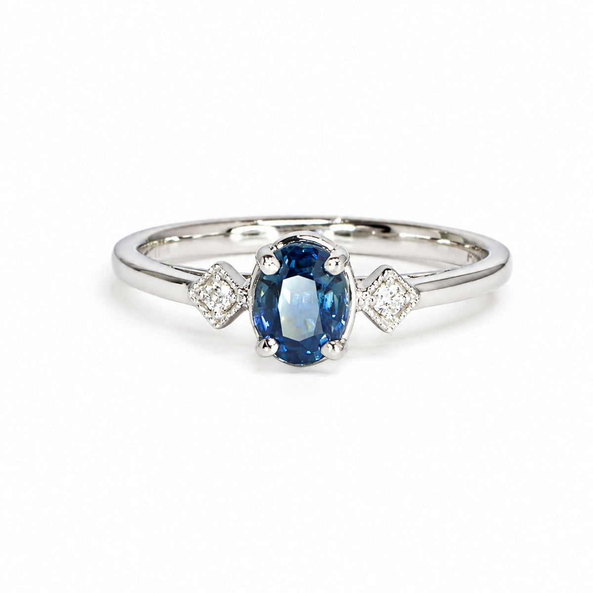 Unheated oval teal sapphire ring with diamond shoulders in white gold