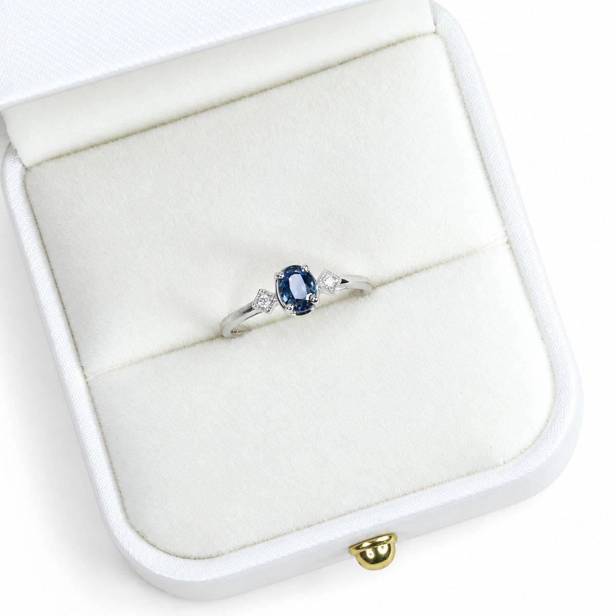 Teal sapphire ring presented in its white gift box