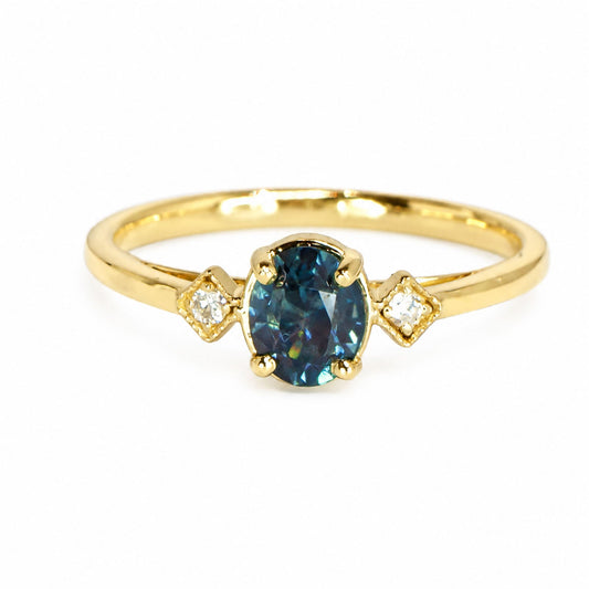 Unheated teal sapphire ring with two diamonds in 18K yellow gold