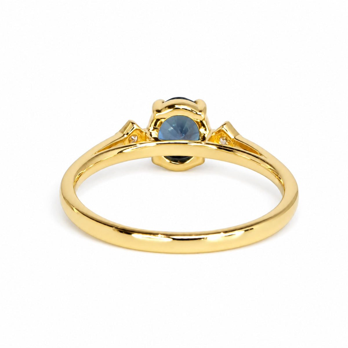 Back of the teal sapphire ring showing the open gold gallery