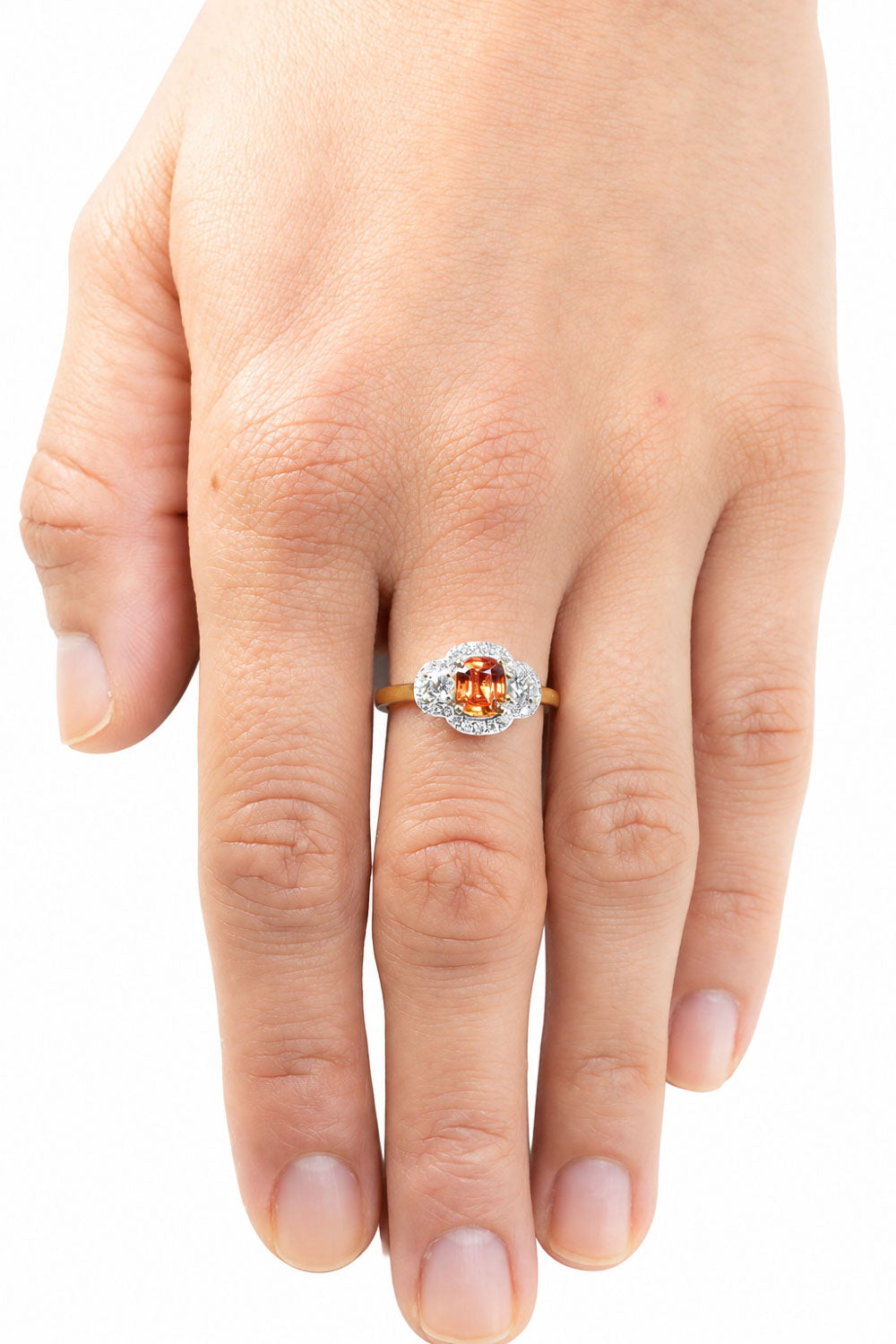 Padparadscha sapphire ring worn on the hand