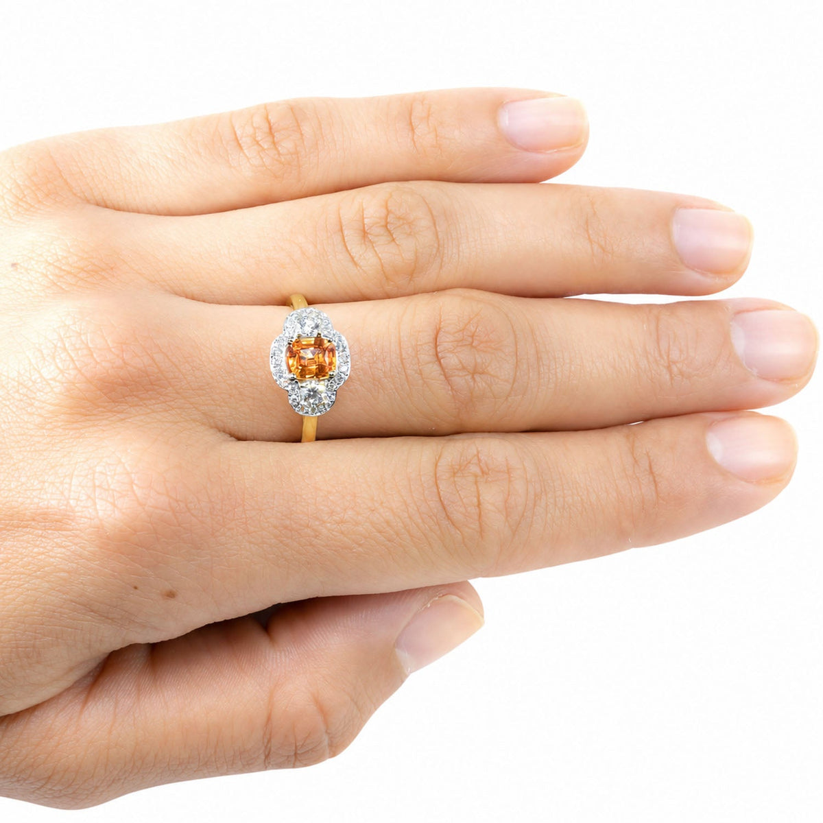 Padparadscha sapphire ring worn, hand resting