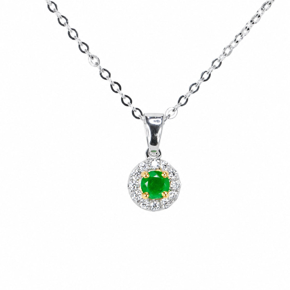 Round Colombian emerald and diamond halo pendant on a white gold chain