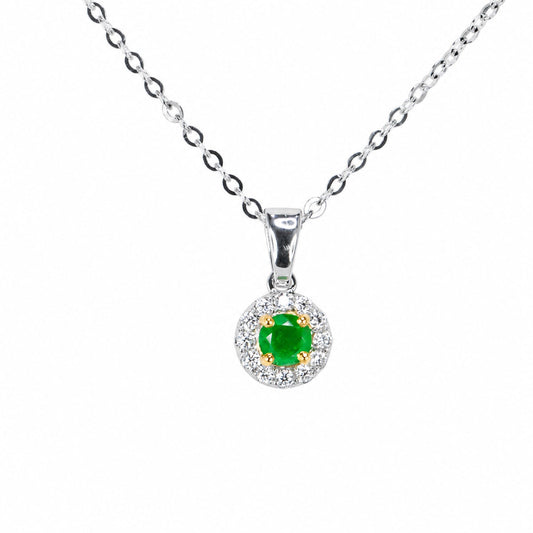 Round Colombian emerald and diamond halo pendant on a white gold chain