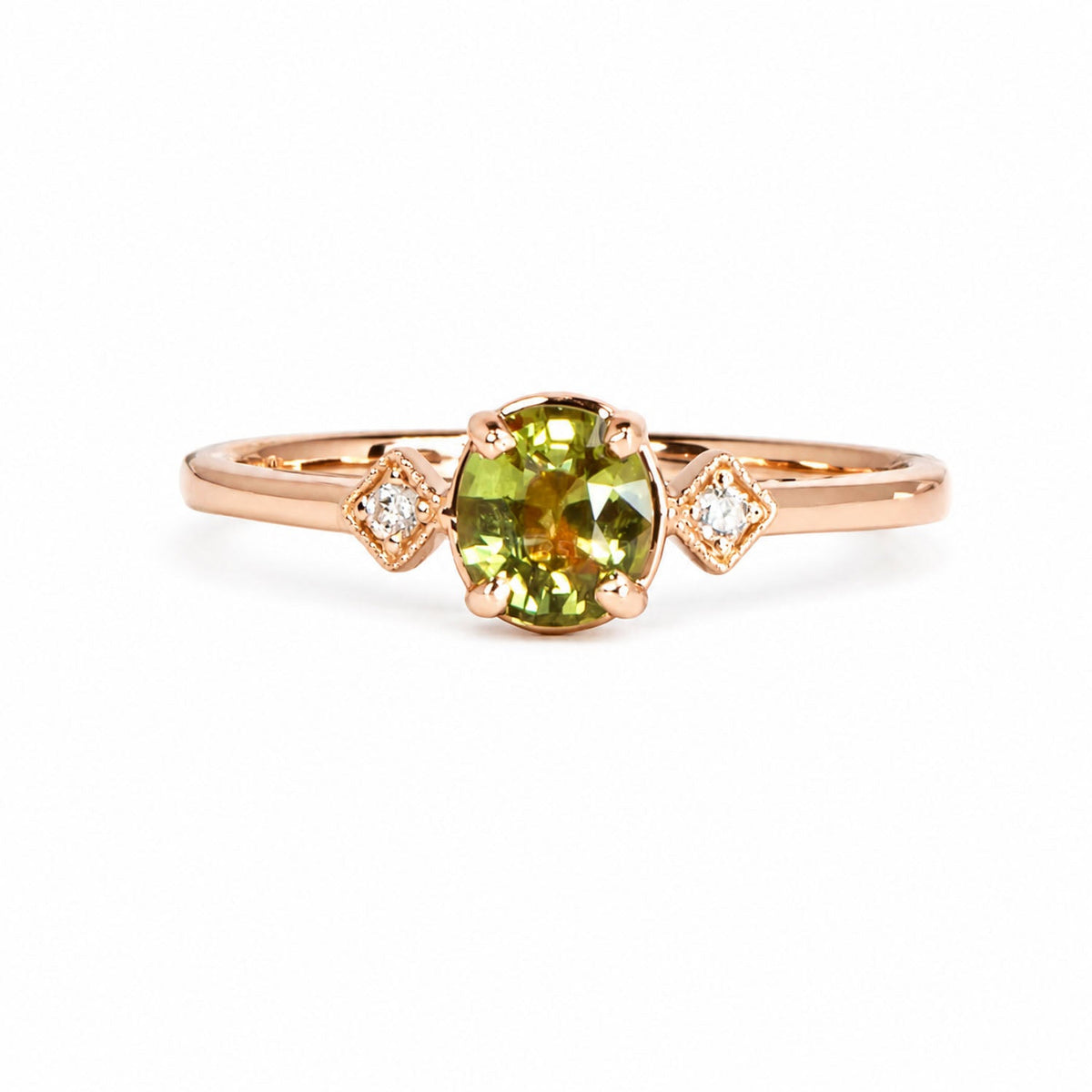 Natural alexandrite ring with two diamonds in rose gold, green in daylight