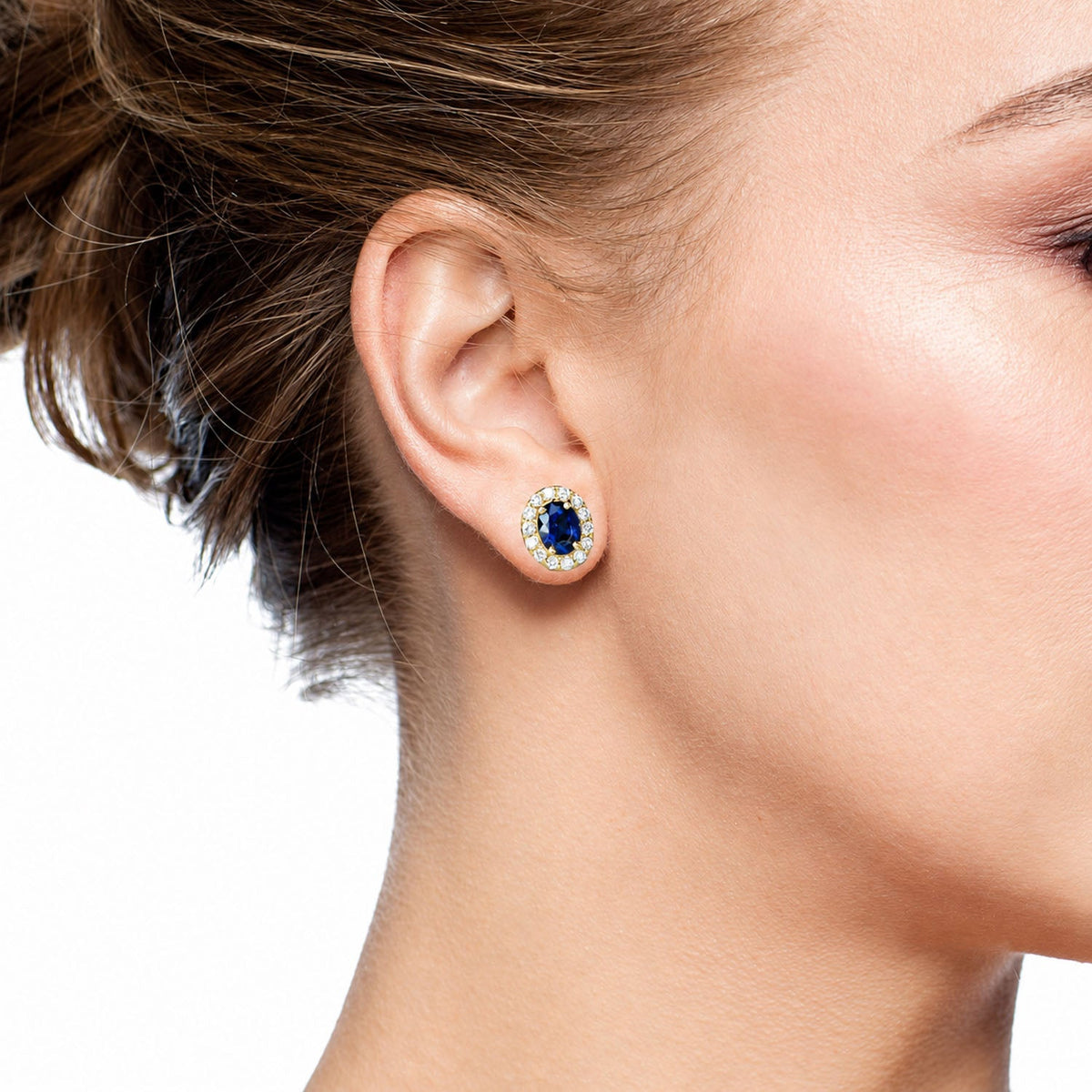 Blue sapphire and diamond stud earring worn, side view